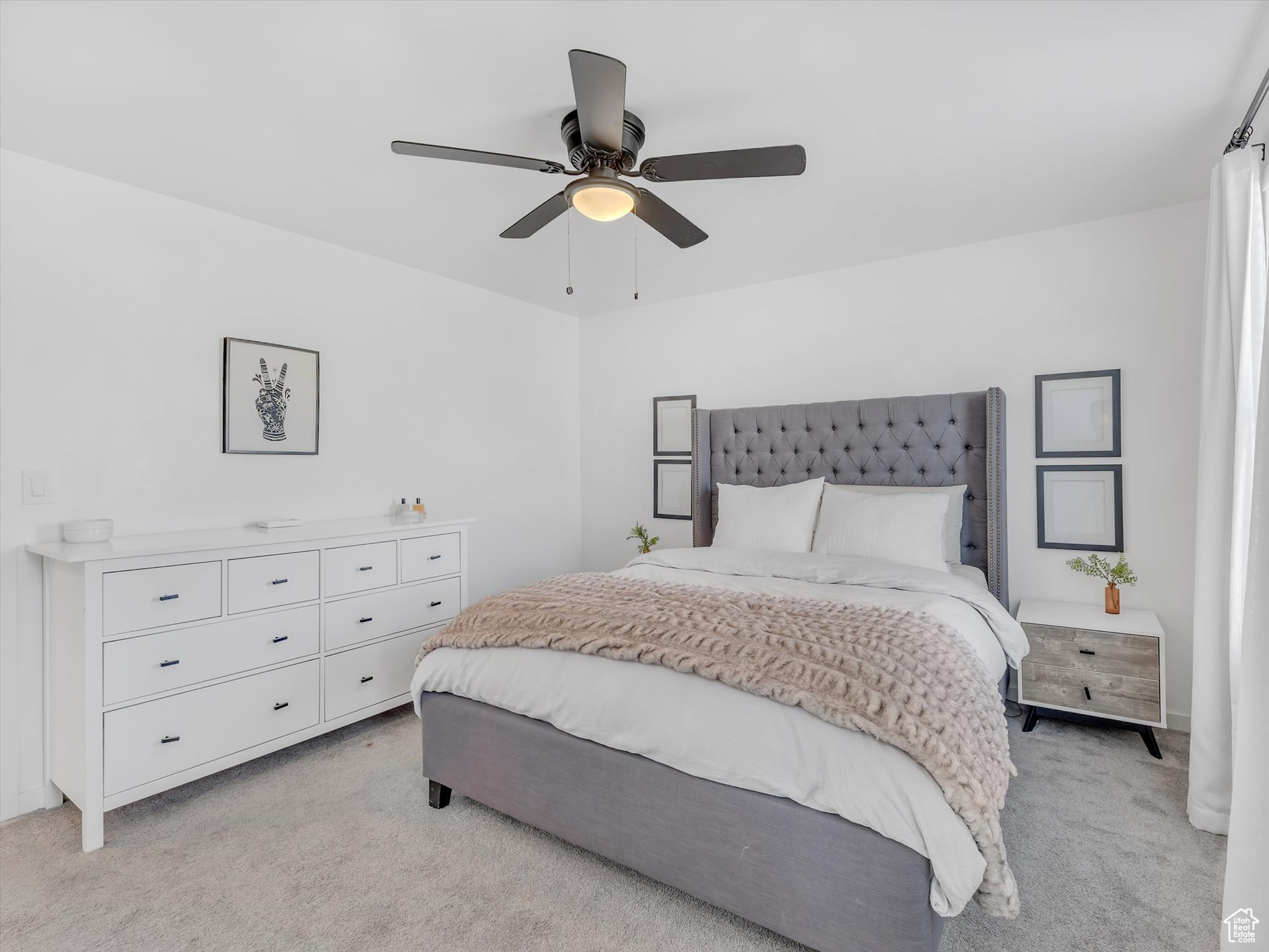 Bedroom featuring a ceiling fan and light colored carpet