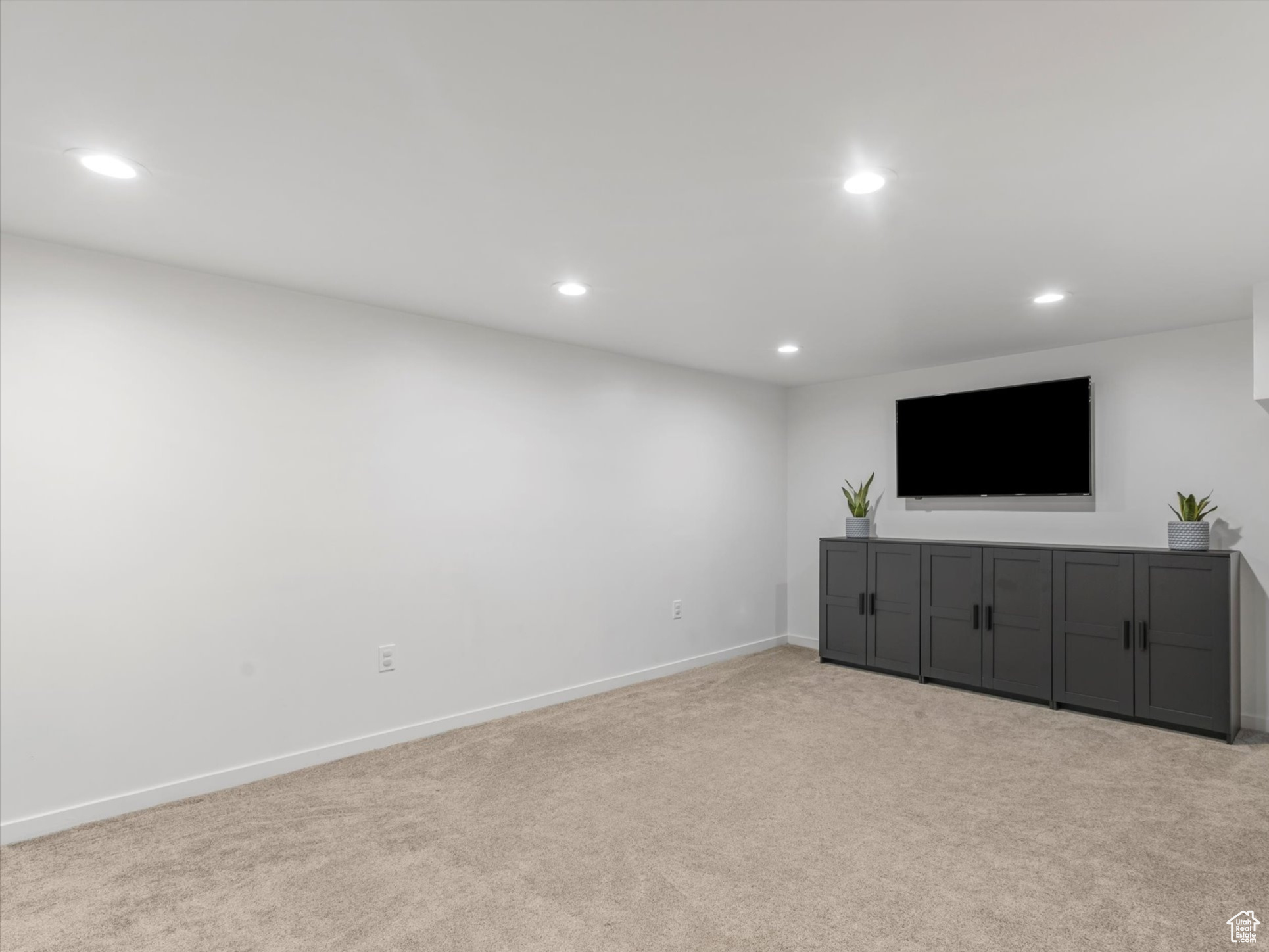 Unfurnished living room with recessed lighting, baseboards, and carpet floors