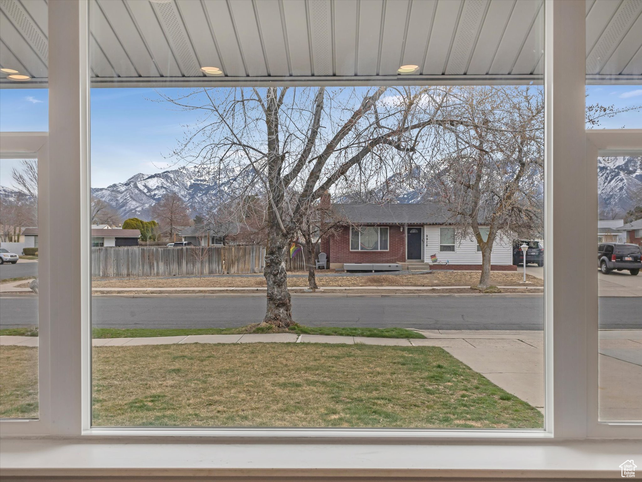 View of yard with a mountain view and fence