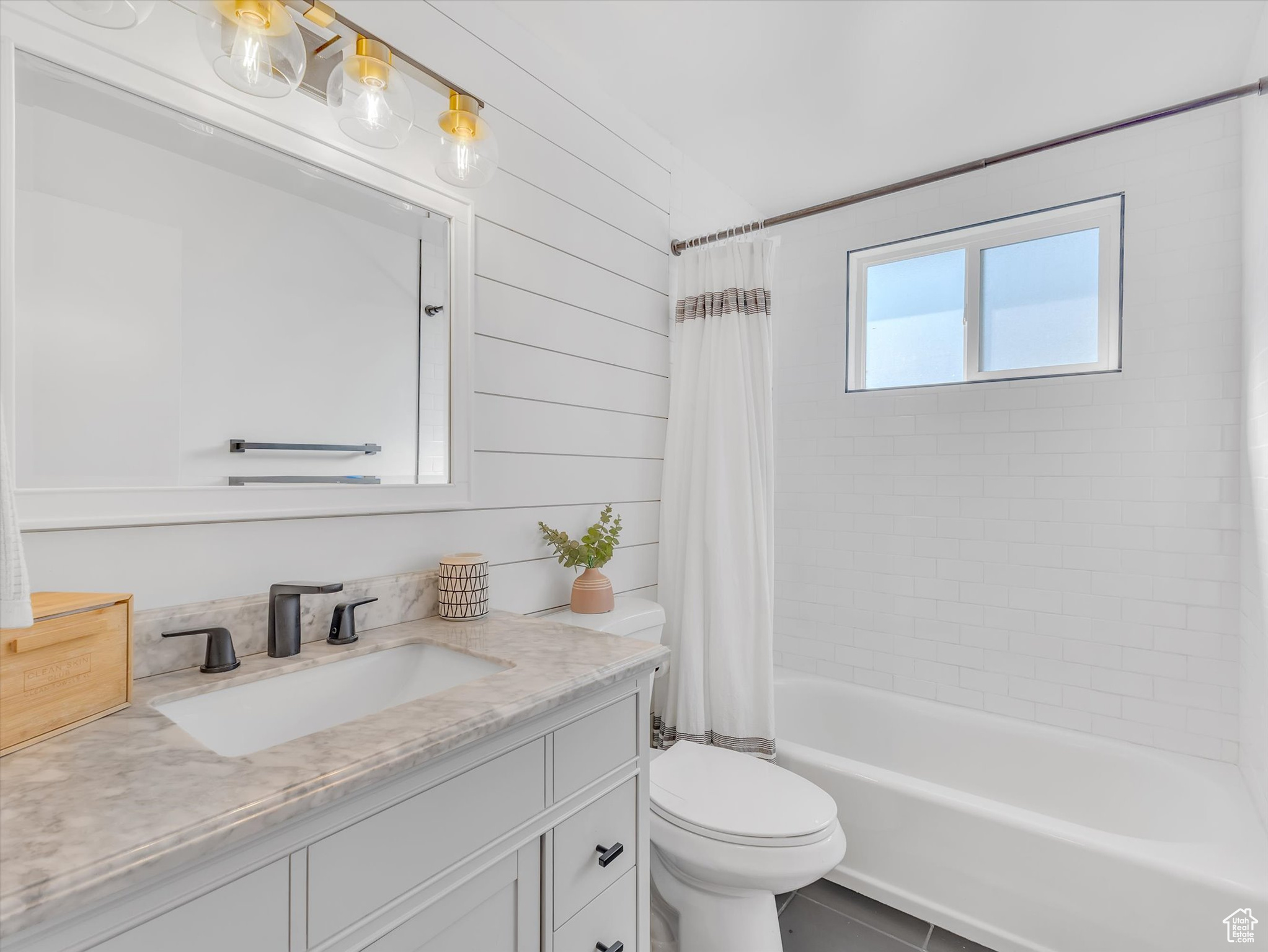 Full bath featuring shower / tub combo, vanity, and toilet
