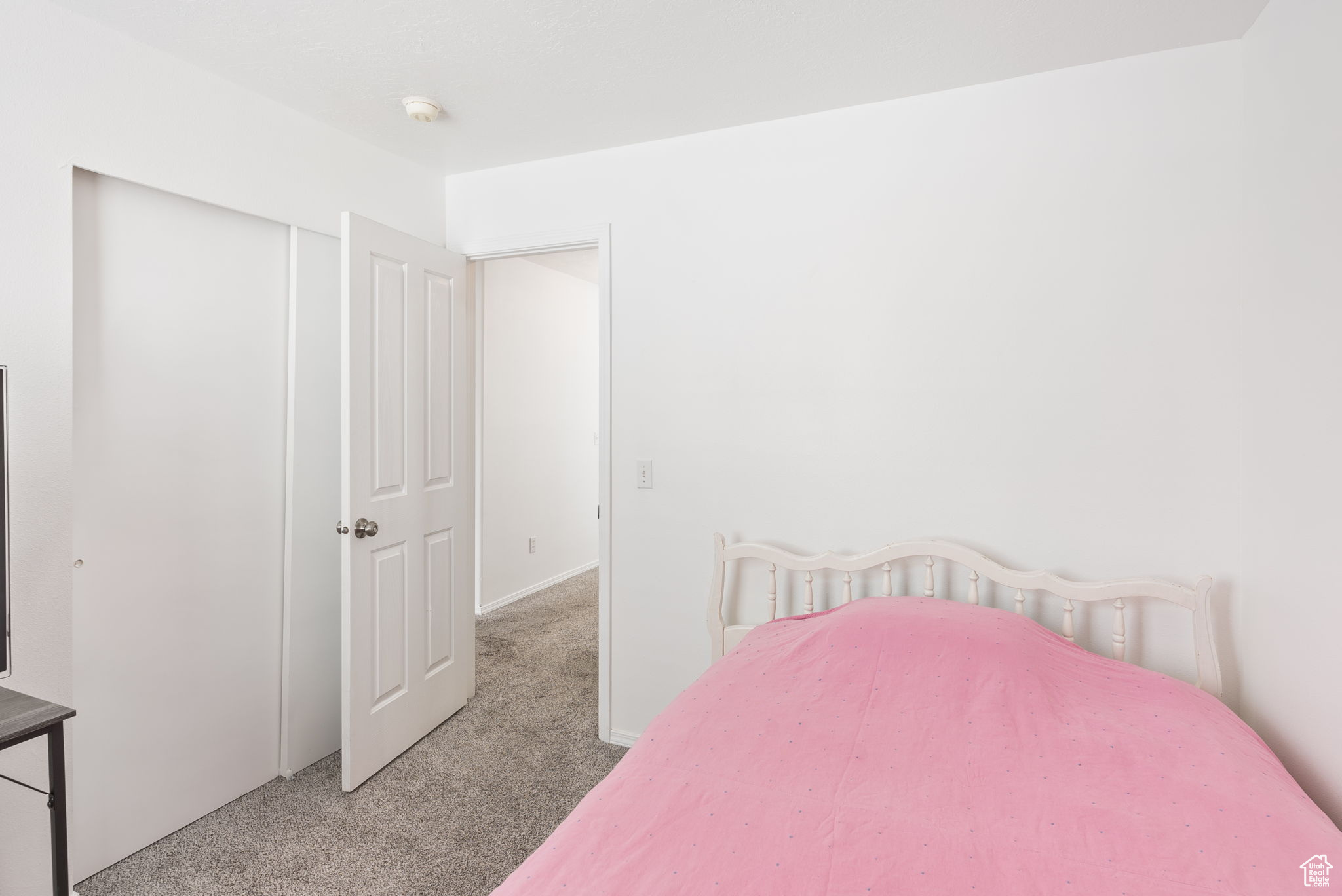 Bedroom with a closet and light colored carpet