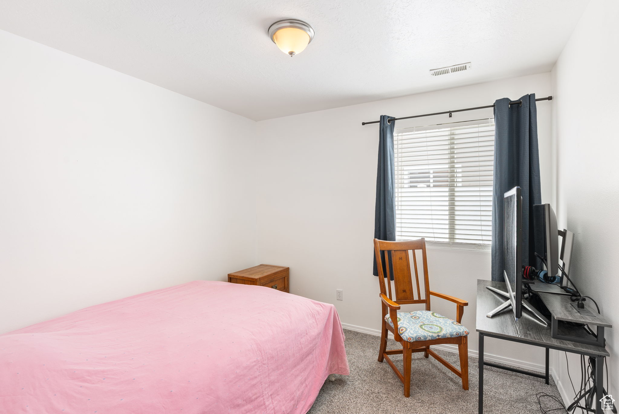 Bedroom with light carpet, baseboards, and visible vents