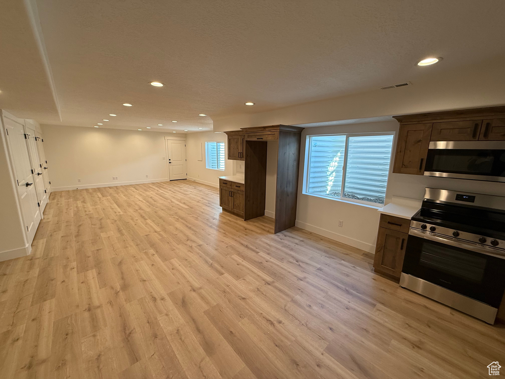 Kitchen featuring visible vents, light wood-style flooring, recessed lighting, stainless steel appliances, and light countertops