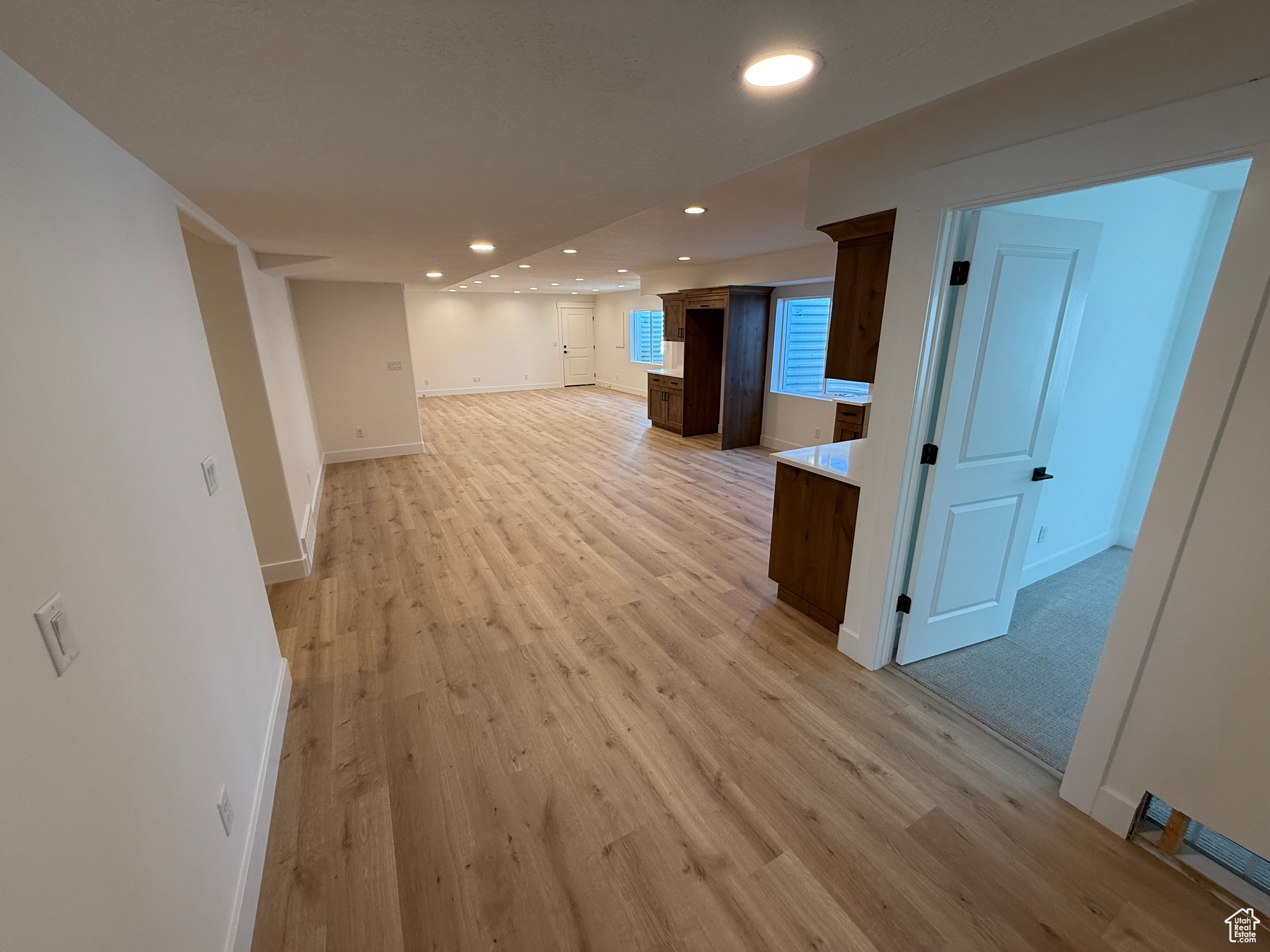 Below grade area featuring recessed lighting, baseboards, and light wood finished floors