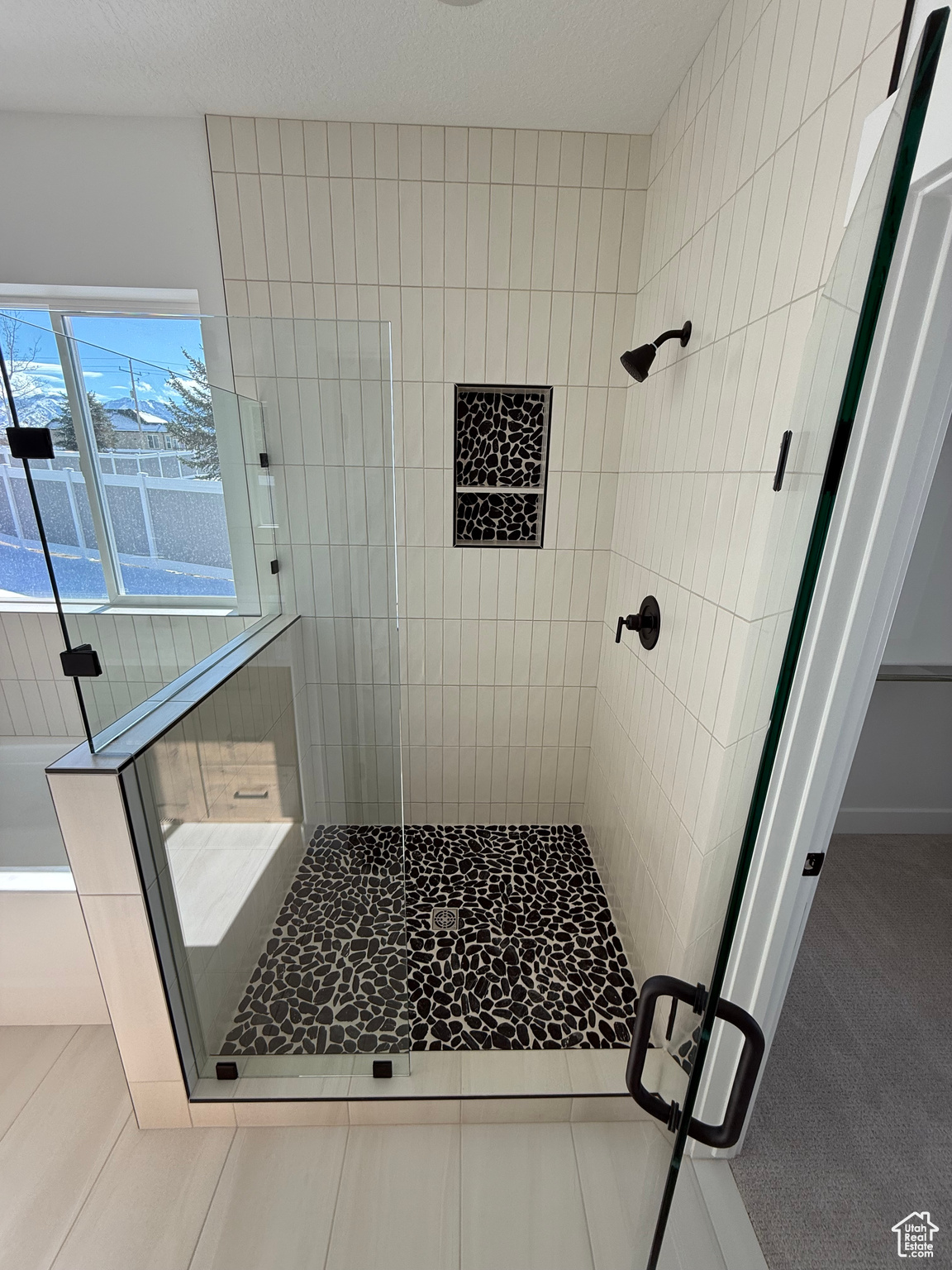 Full bathroom with a stall shower and a bath