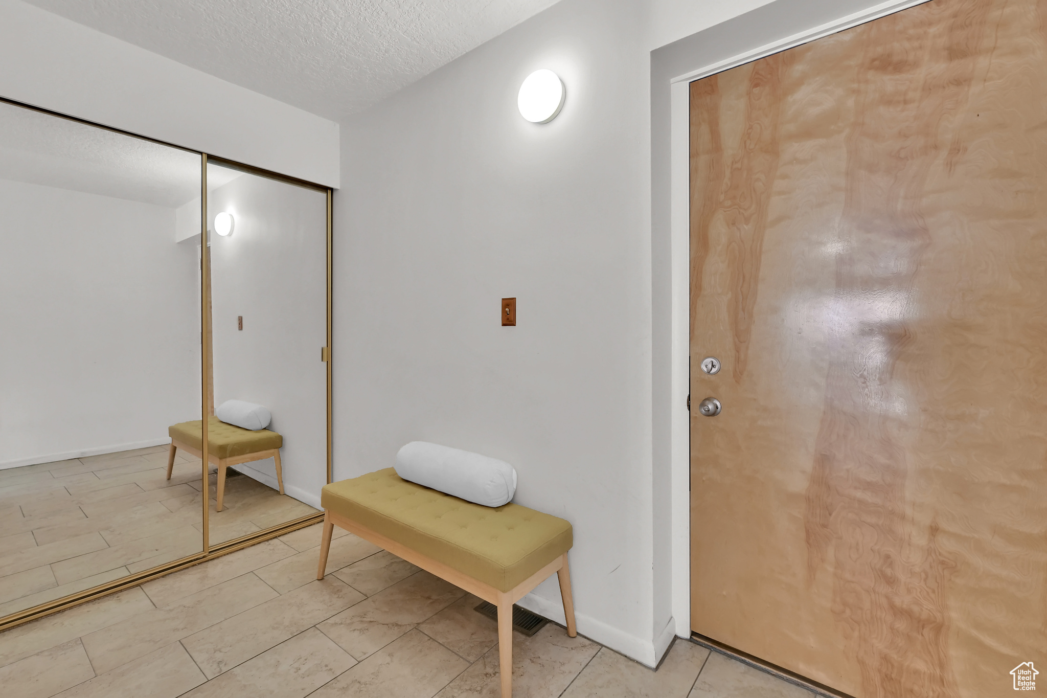 Interior space featuring a textured ceiling and baseboards