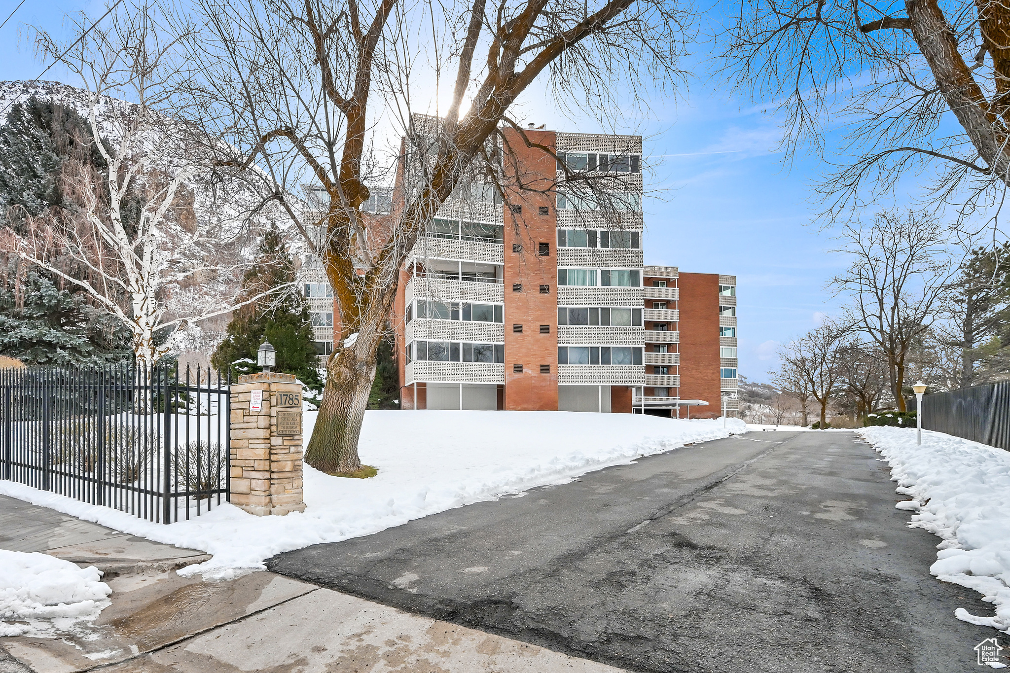 Snow covered property with fence