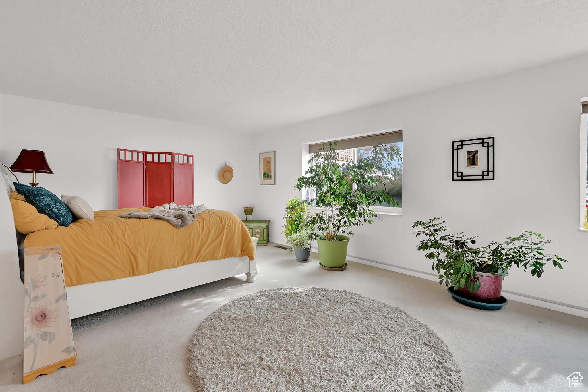 Bedroom featuring carpet floors, baseboards, and a textured ceiling