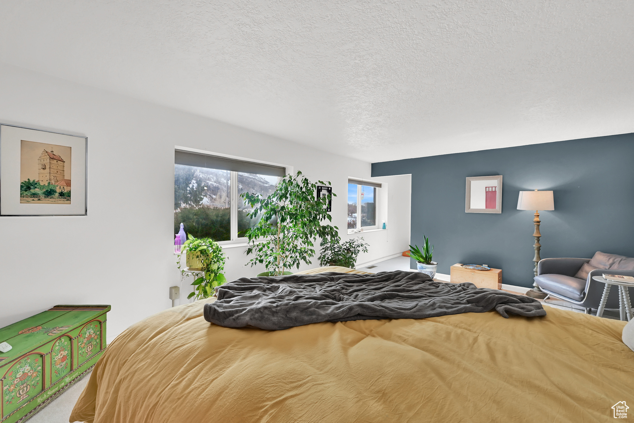 Bedroom featuring a textured ceiling and baseboards
