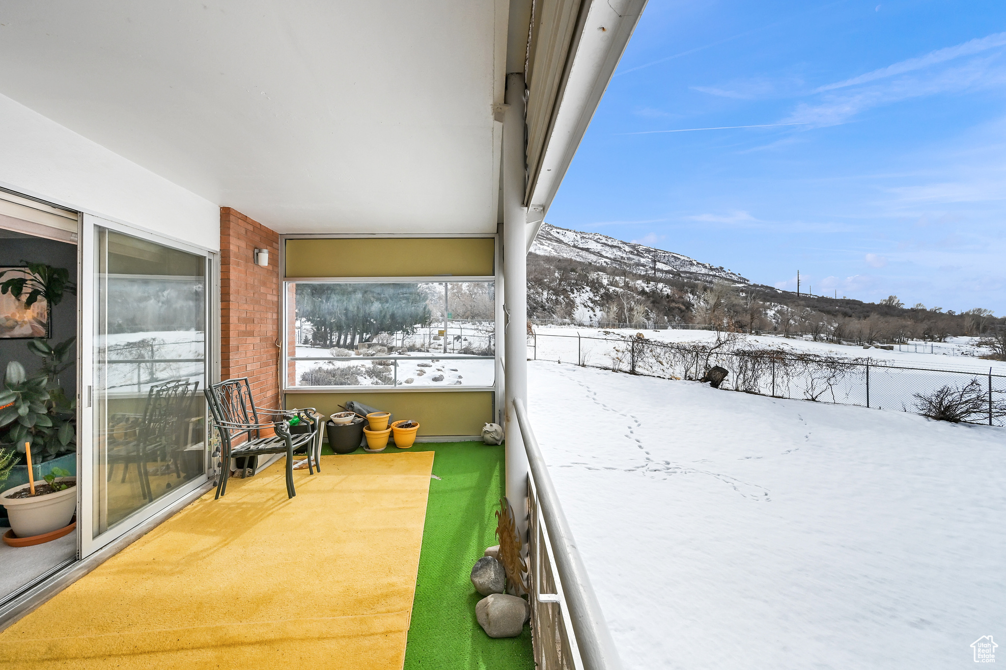 Snow covered back of property featuring a mountain view