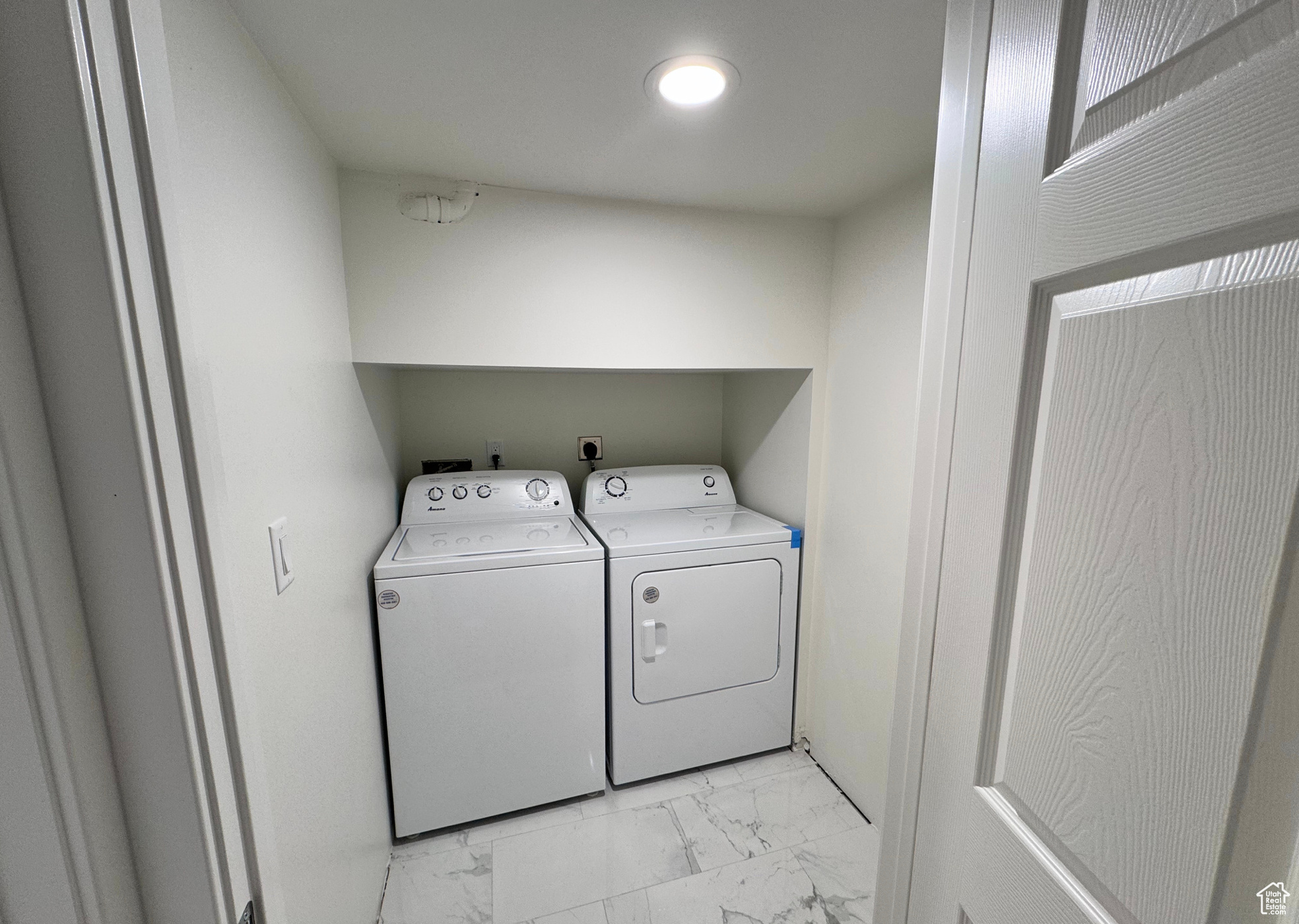 Laundry area featuring laundry area, marble finish floor, and washer and clothes dryer