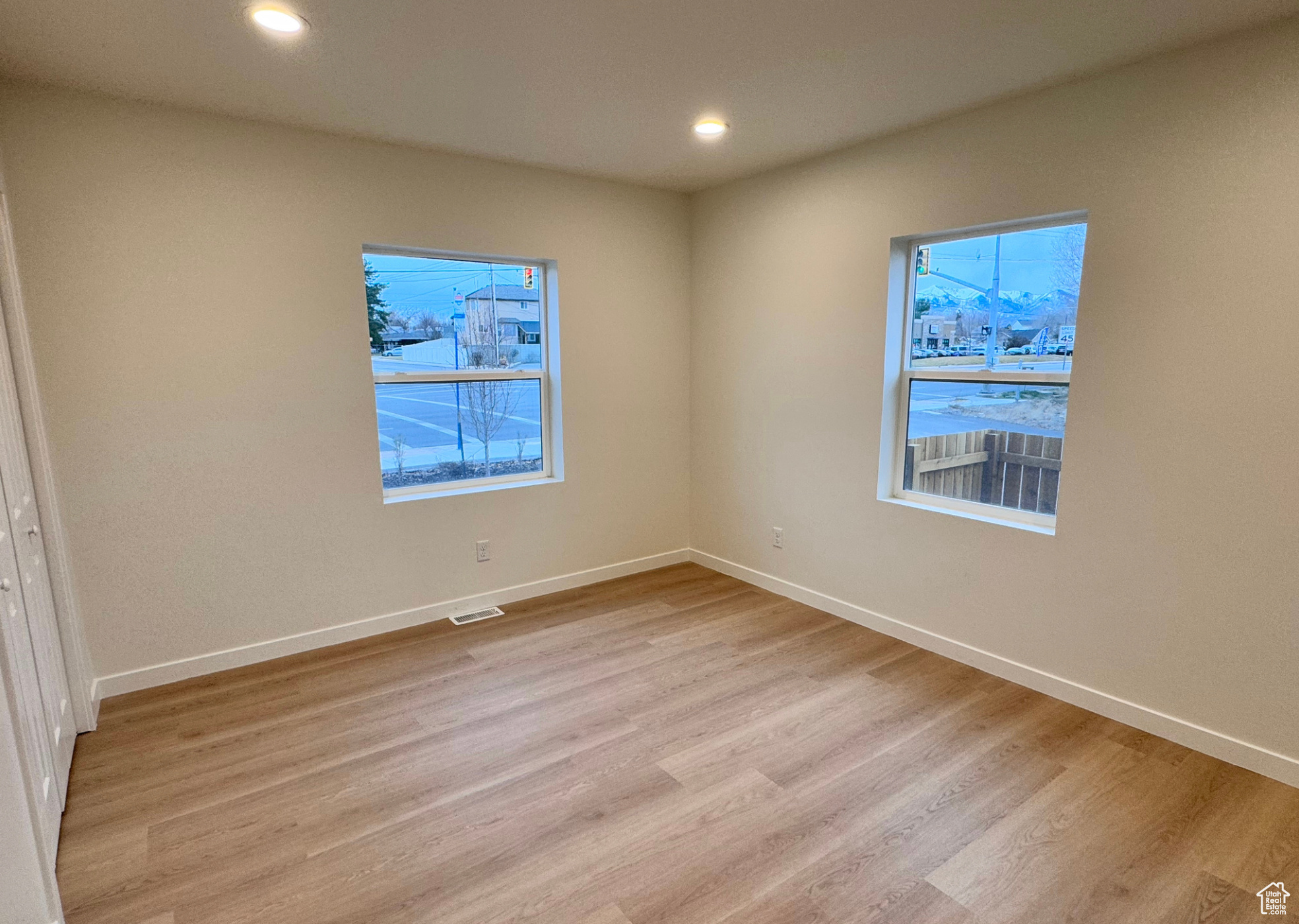 Spare room featuring recessed lighting, visible vents, light wood-style flooring, and baseboards