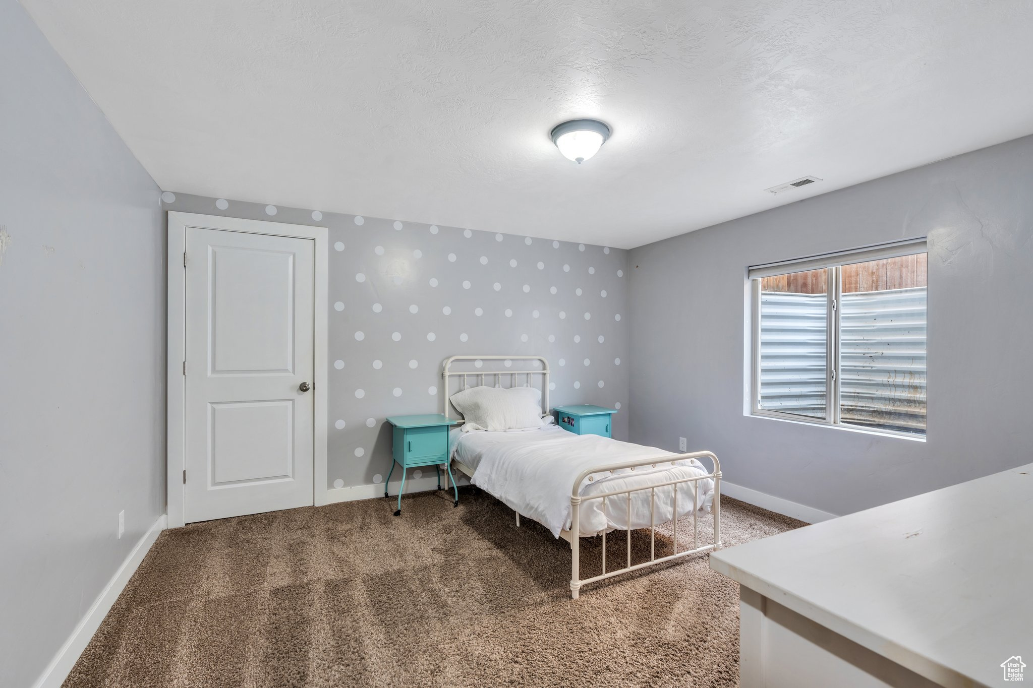 Bedroom with baseboards, visible vents, and carpet flooring