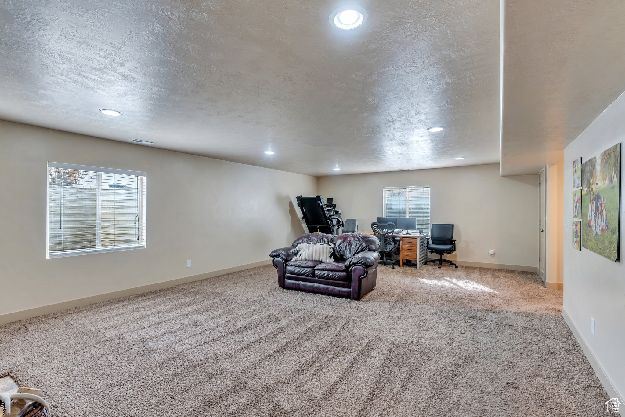 Unfurnished room featuring visible vents, baseboards, carpet, a textured ceiling, and recessed lighting