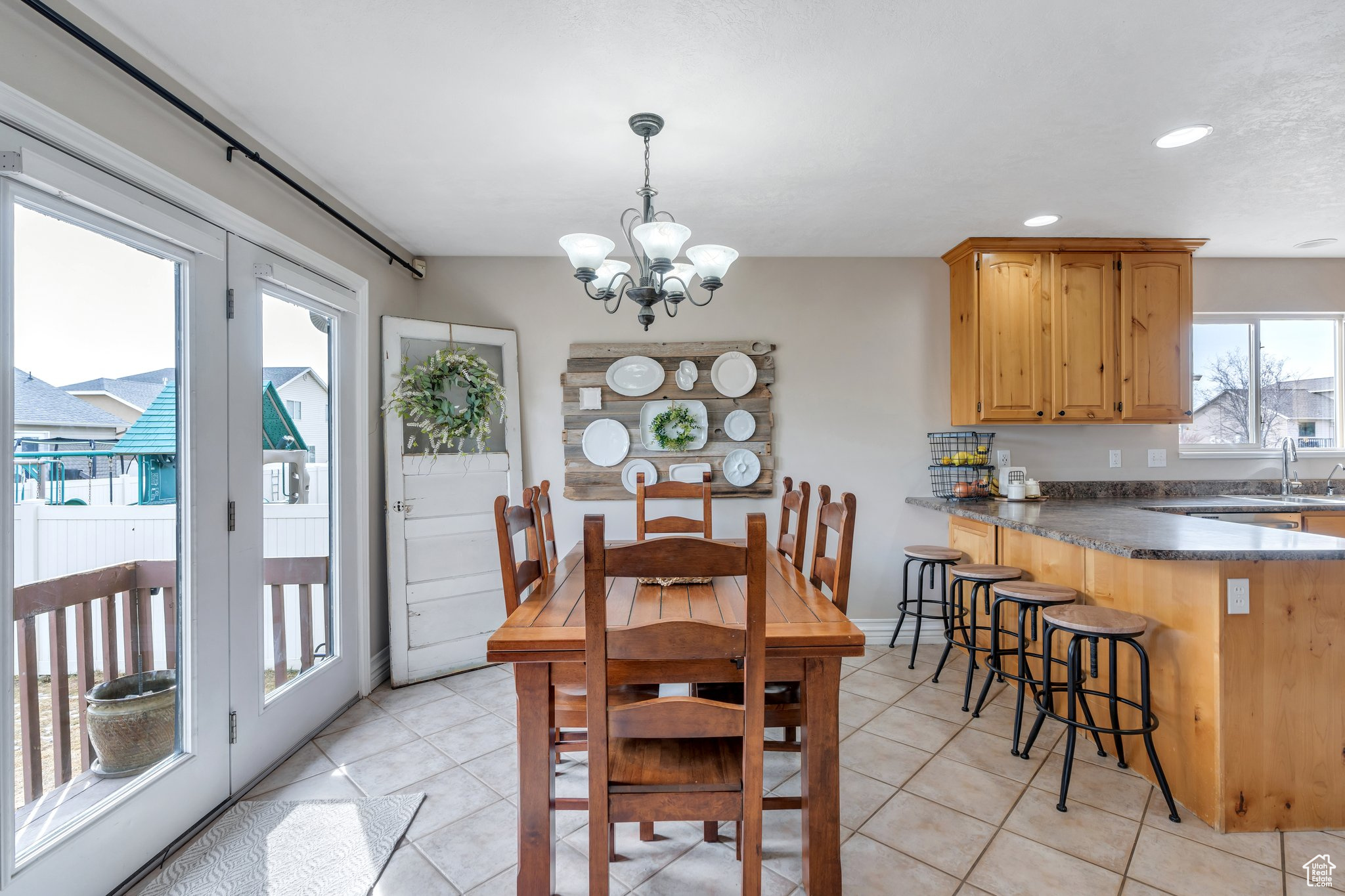 Dining area with recessed lighting, baseboards, an inviting chandelier, and light tile patterned floors
