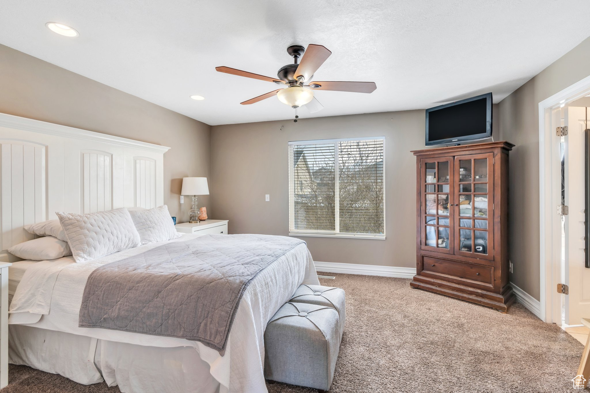Carpeted bedroom featuring a ceiling fan, recessed lighting, and baseboards