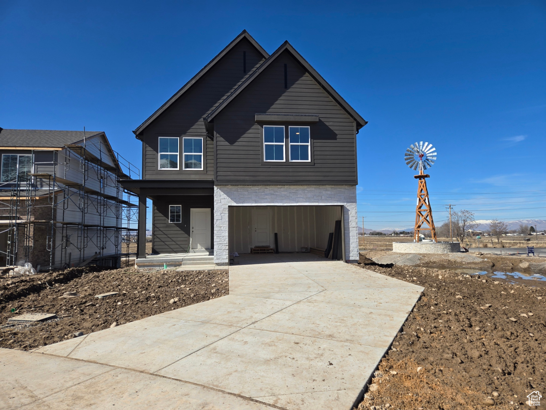 View of front of property with a garage and concrete driveway