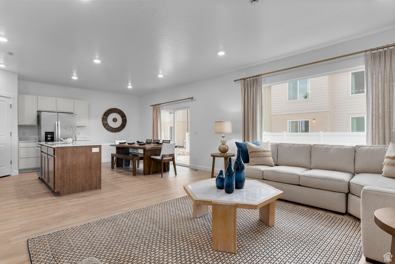 Living room featuring recessed lighting, light wood-style flooring, and baseboards