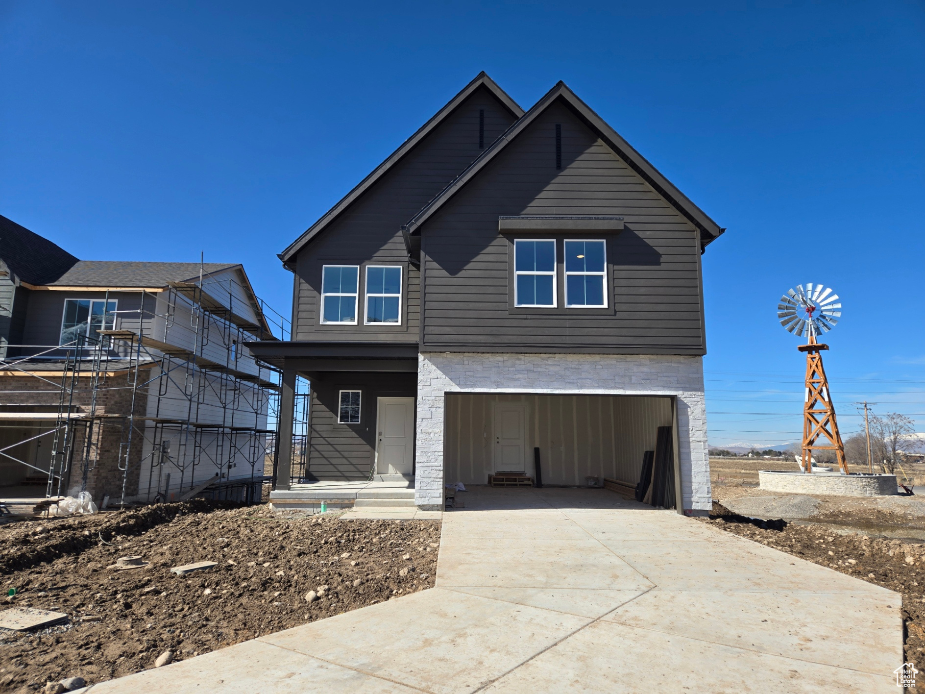 View of front of home with driveway and an attached garage