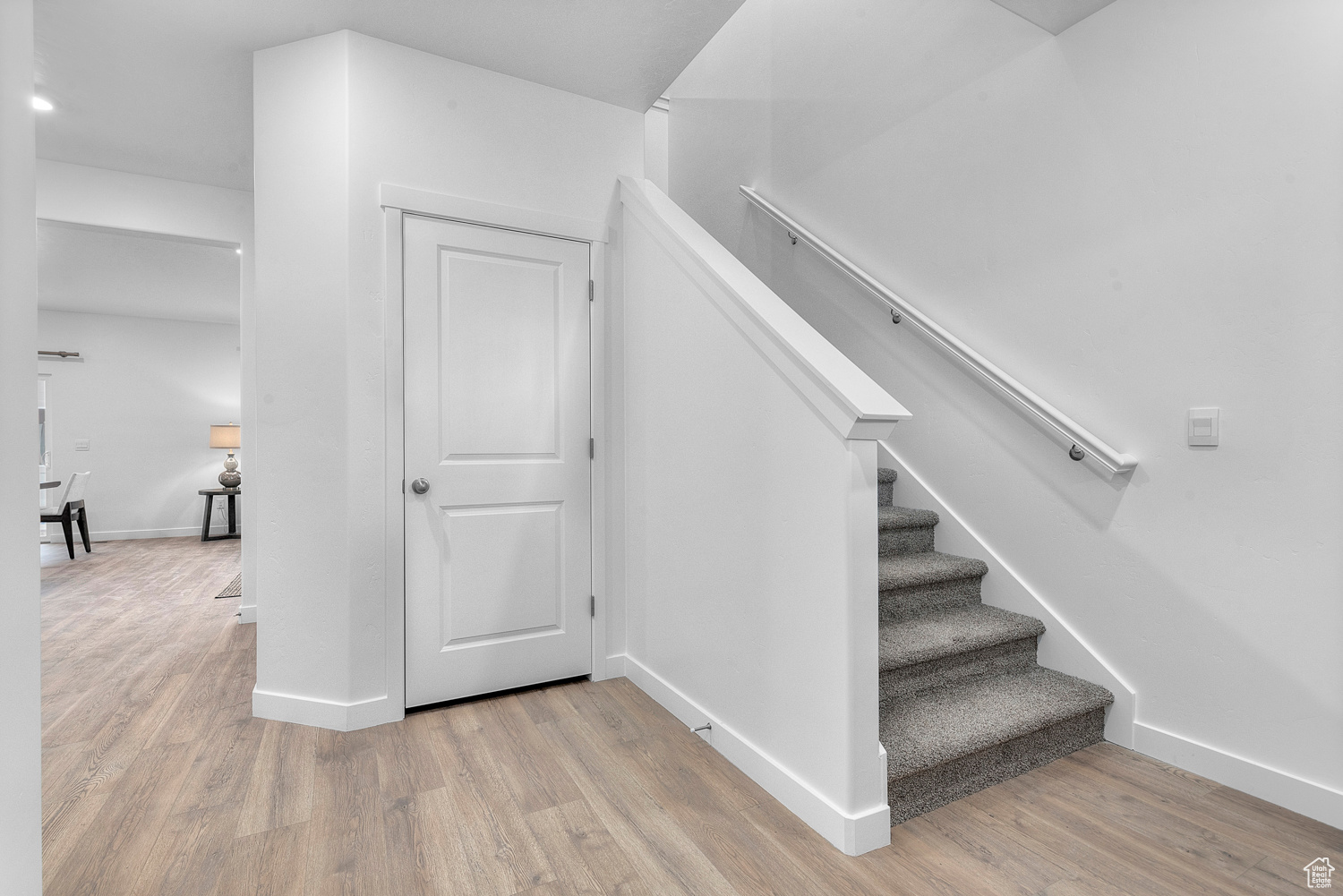 Stairs featuring baseboards and wood finished floors