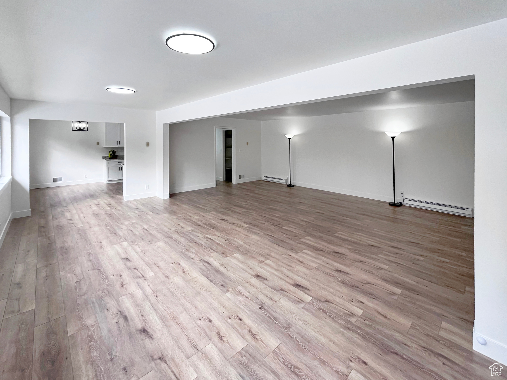 Living area featuring light wood-style floors in a large gathering area