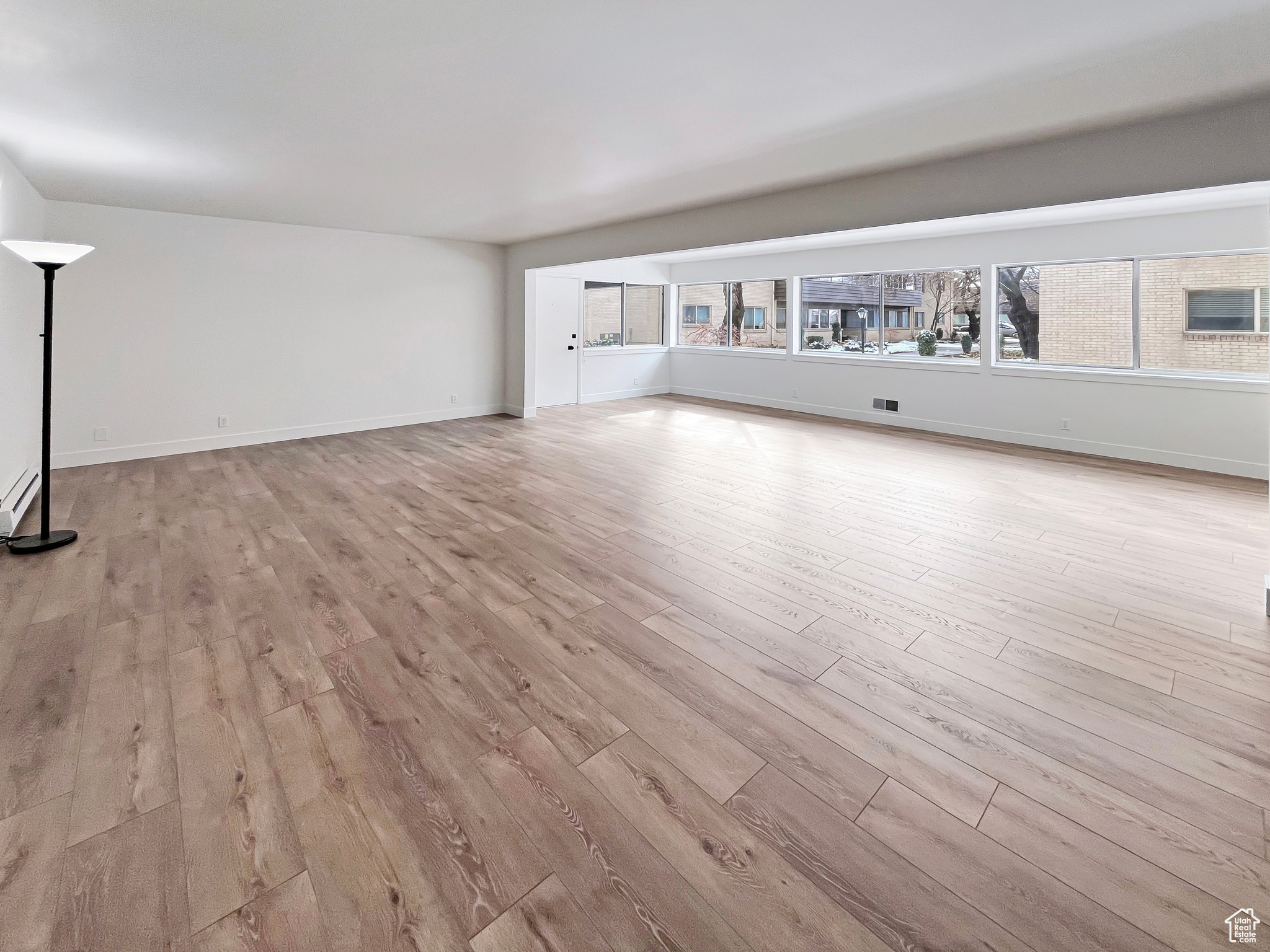 Living area with light wood finished floors and convenient natural daylight