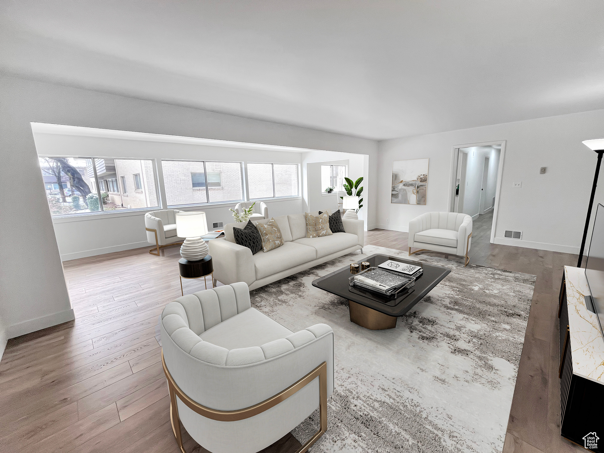 Virtually staged living area with a healthy amount of sunlight, light wood-style flooring and tasteful interior colors