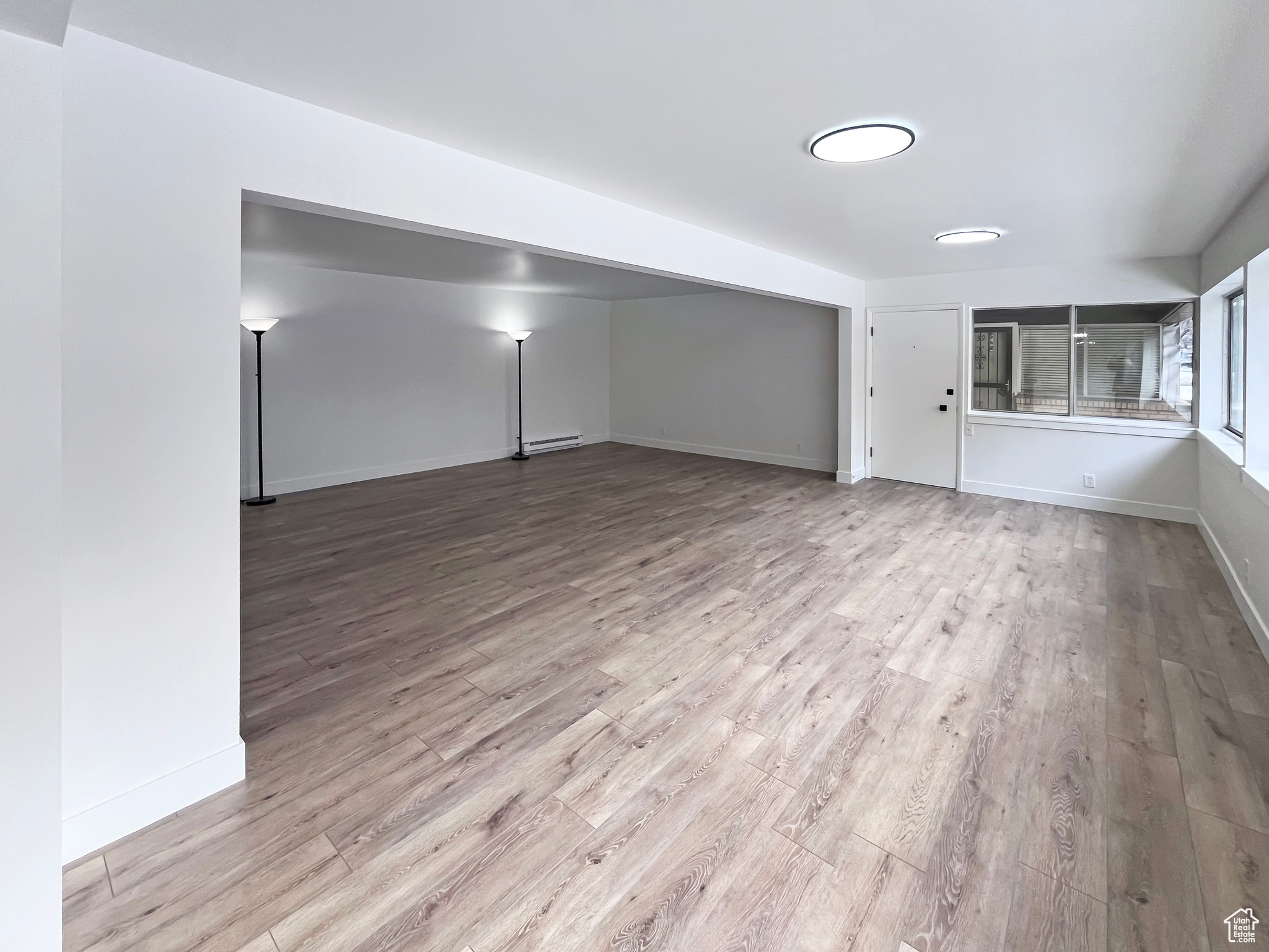 Living area with light wood-style flooring and open style floorplan