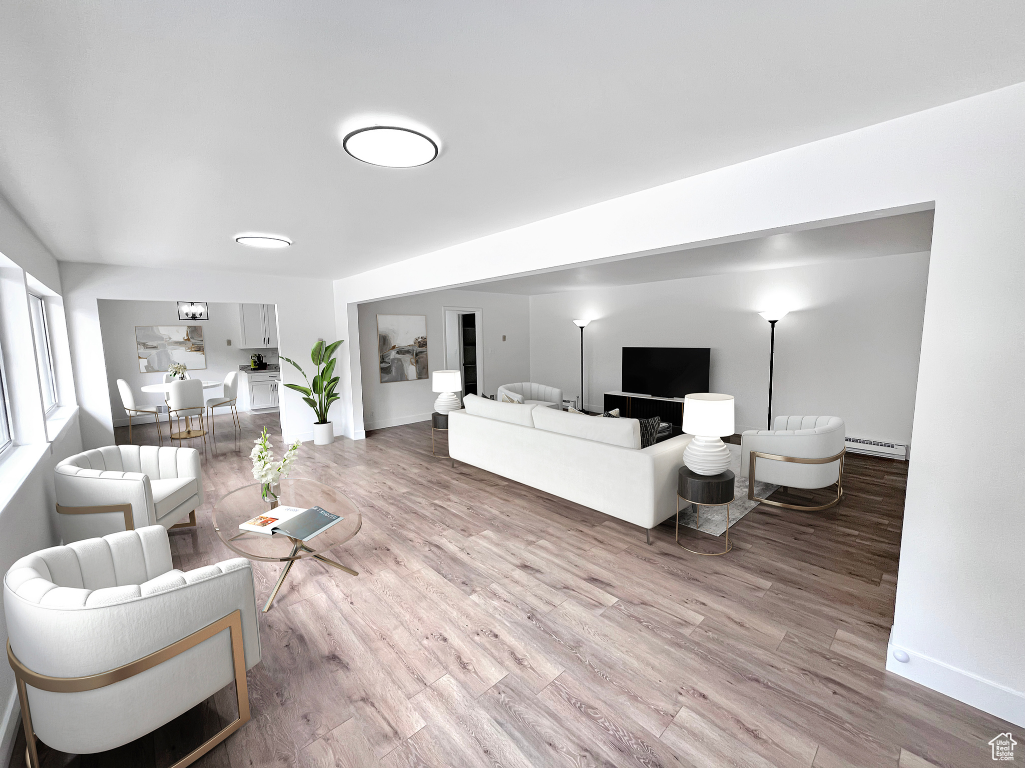 Virtually staged living area featuring light wood-style floors in a large gathering area