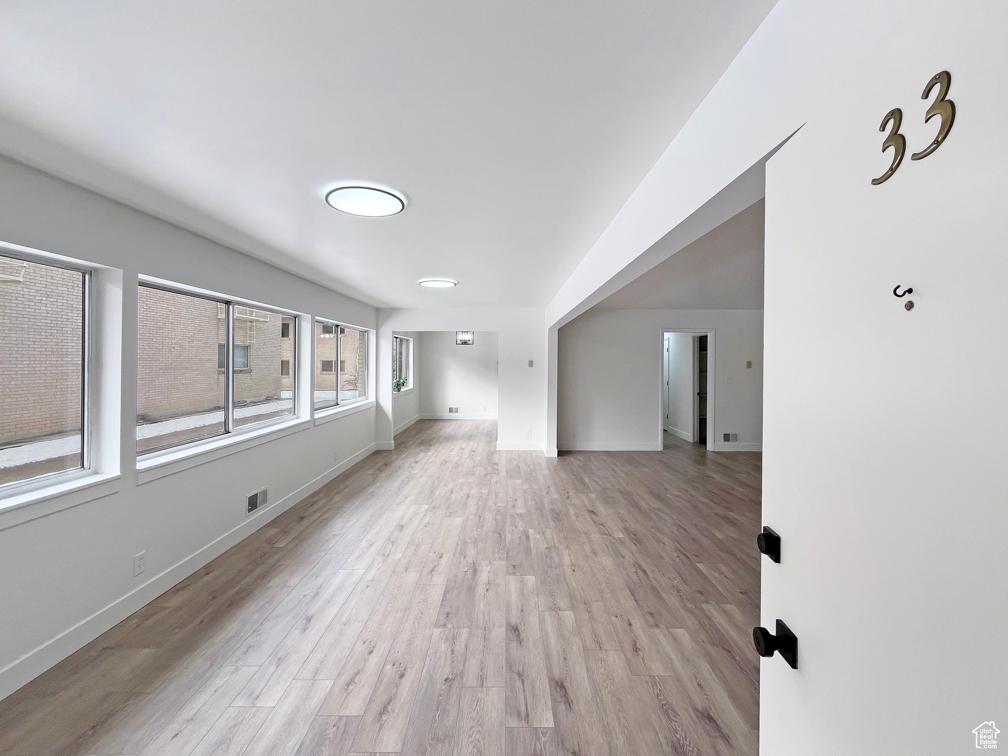 Living area featuring light wood-style floors and ample lighting