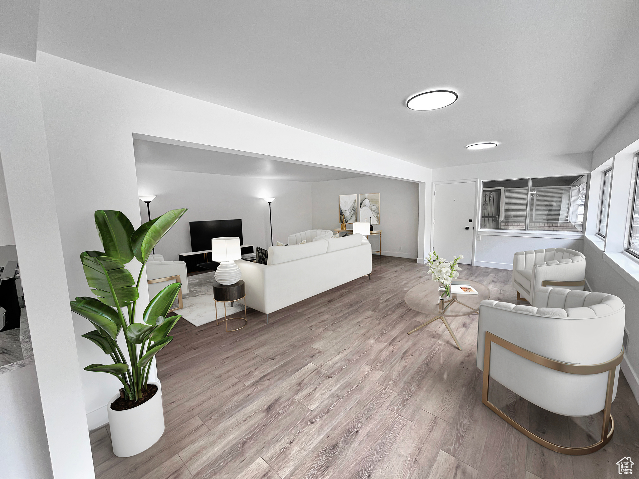 Virtually staged living area with light wood-style flooring and open style floorplan