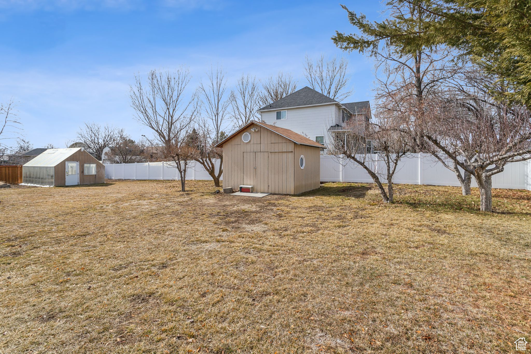 View of yard with an outbuilding, a fenced backyard, and a shed