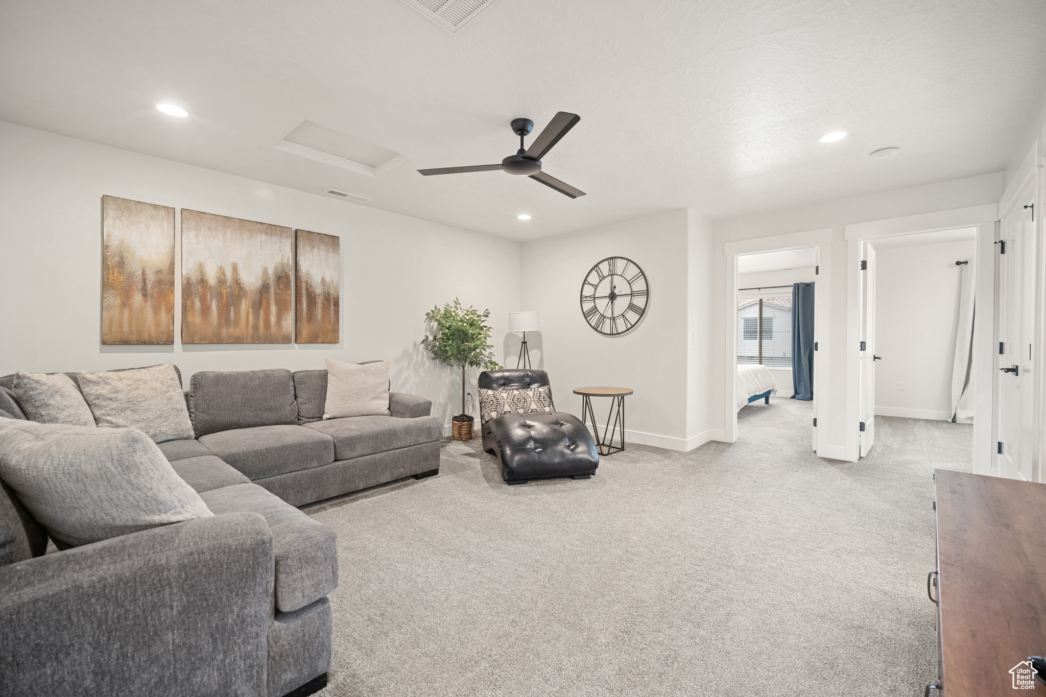 Living area with recessed lighting, visible vents, baseboards, carpet, and attic access