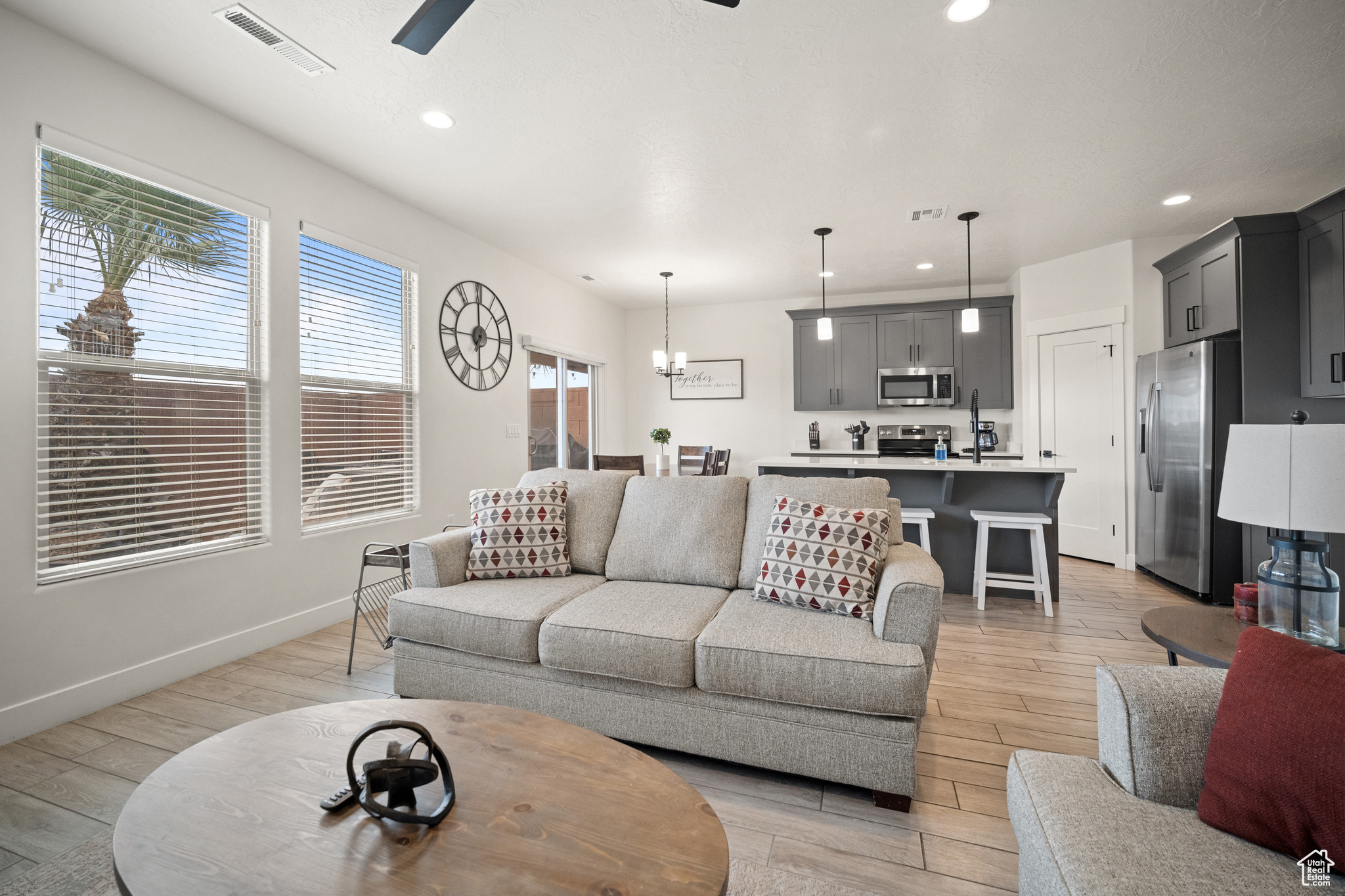 Living area featuring light wood finished floors, visible vents, and recessed lighting