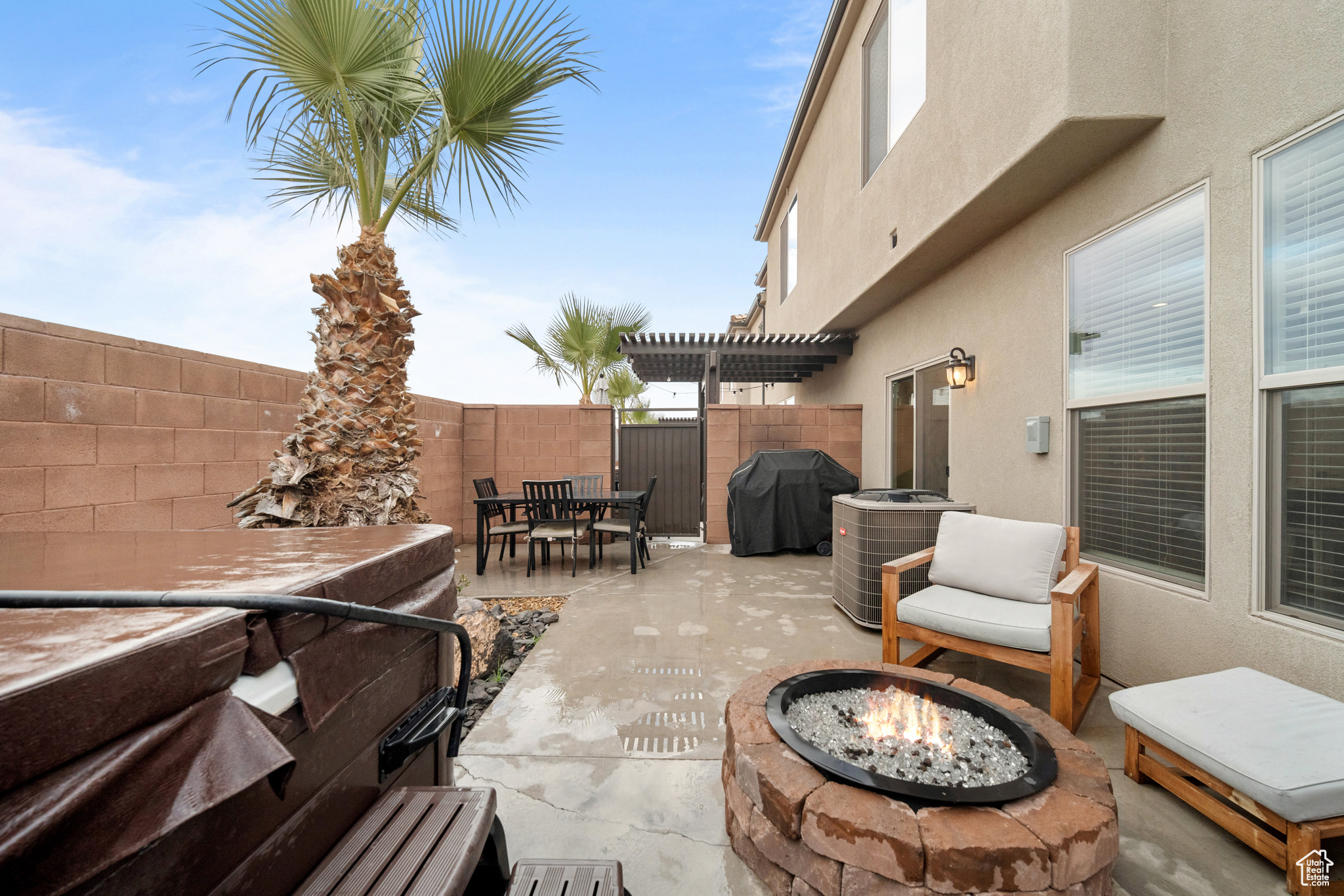 View of patio with outdoor dining area, a fenced backyard, a fire pit, a grill, and a pergola