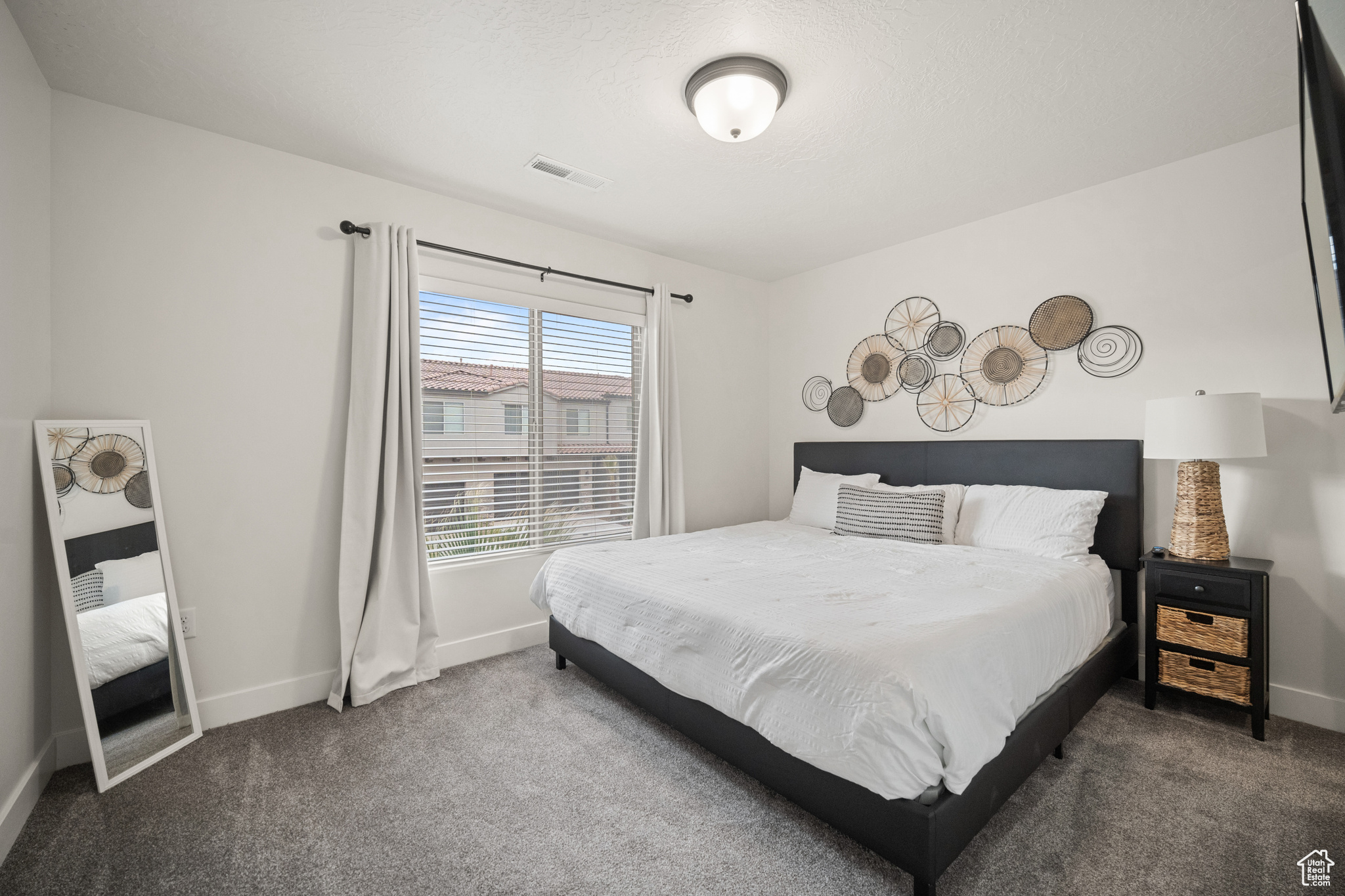 Bedroom featuring carpet floors, baseboards, and visible vents