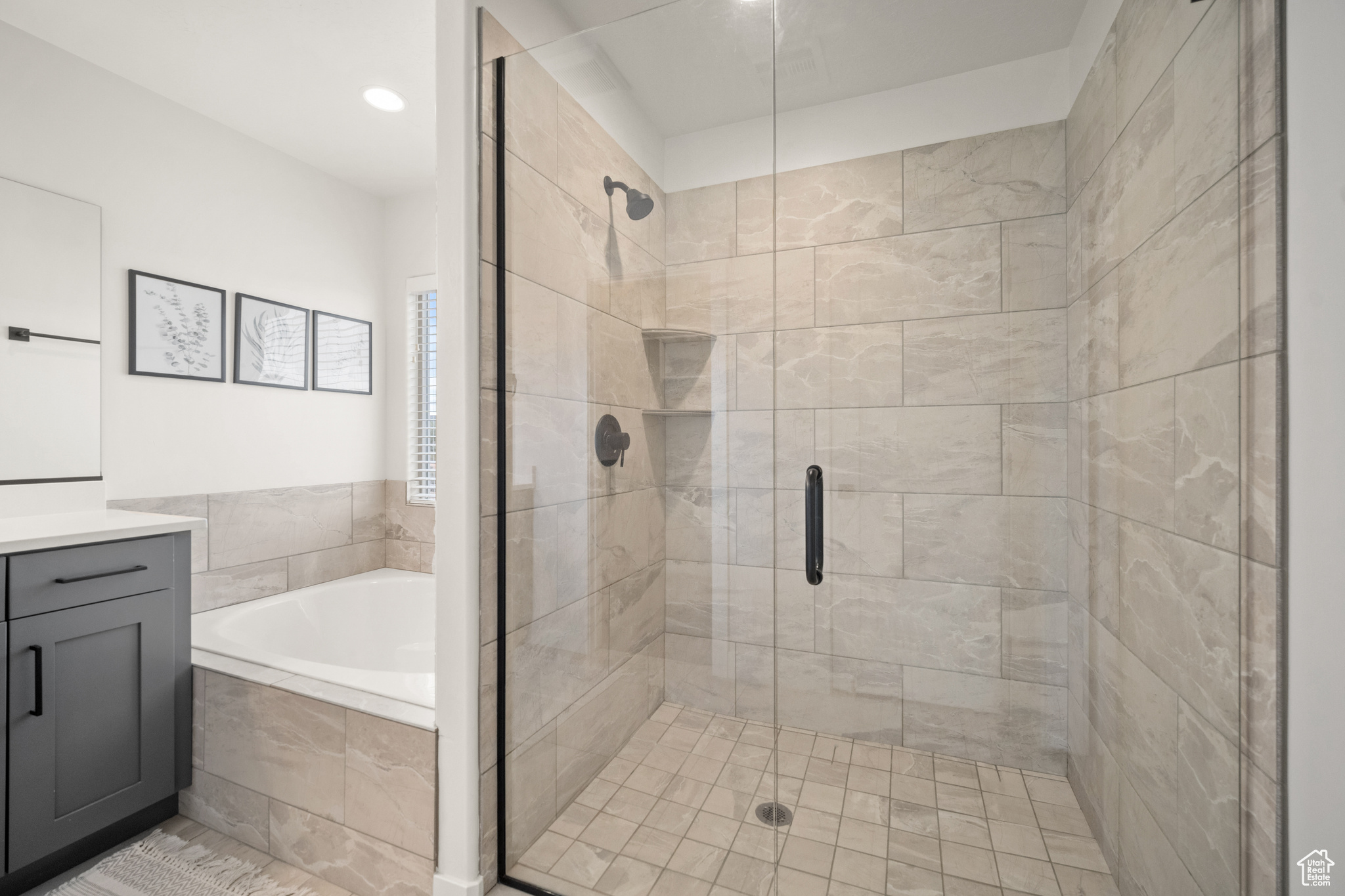 Bathroom featuring a garden tub, vanity, and a stall shower