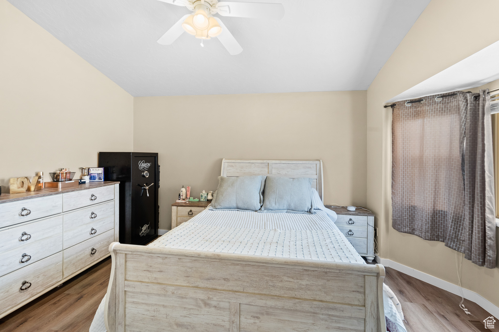 Bedroom featuring lofted ceiling, ceiling fan, wood finished floors, and baseboards