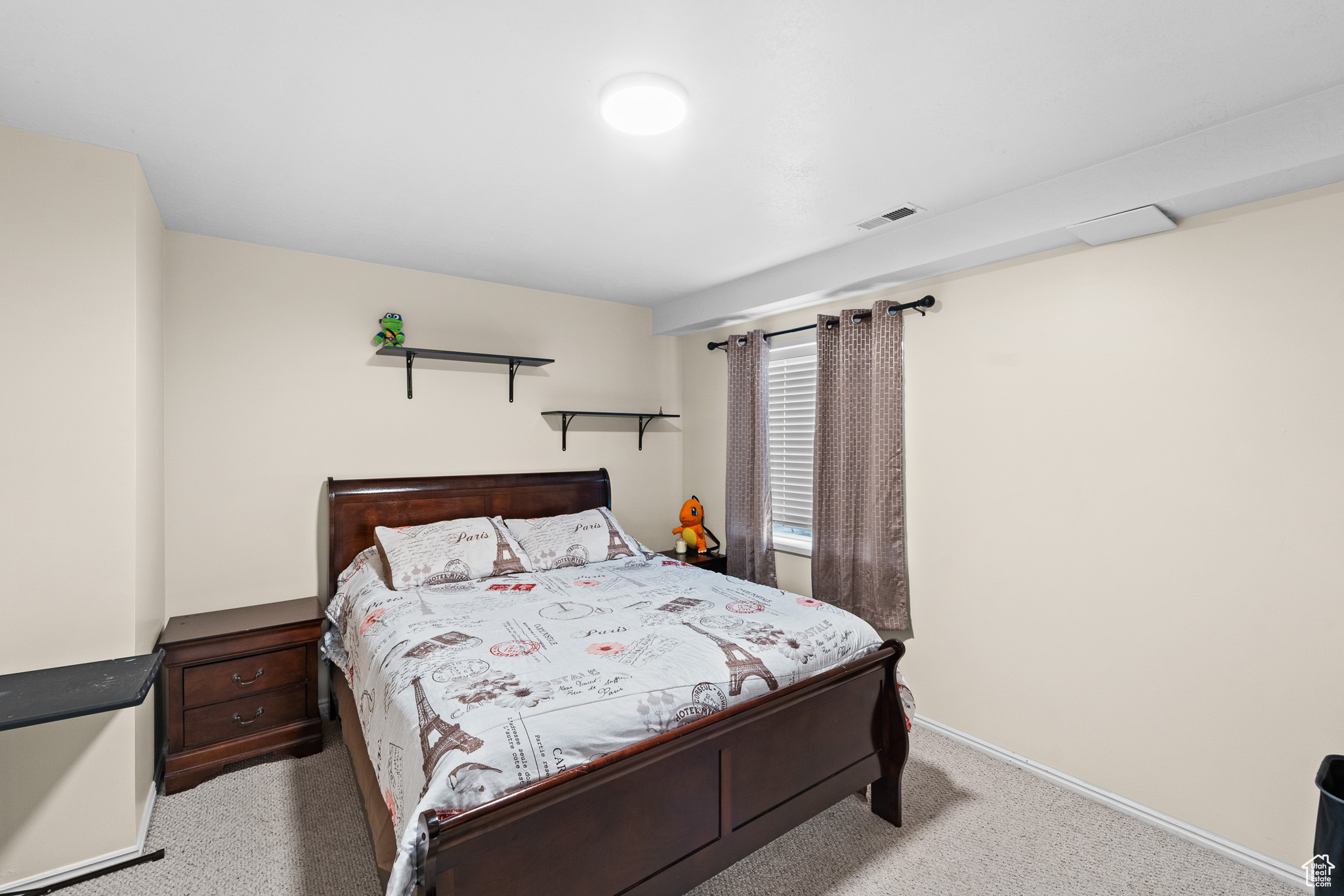 Bedroom with light carpet, baseboards, and visible vents