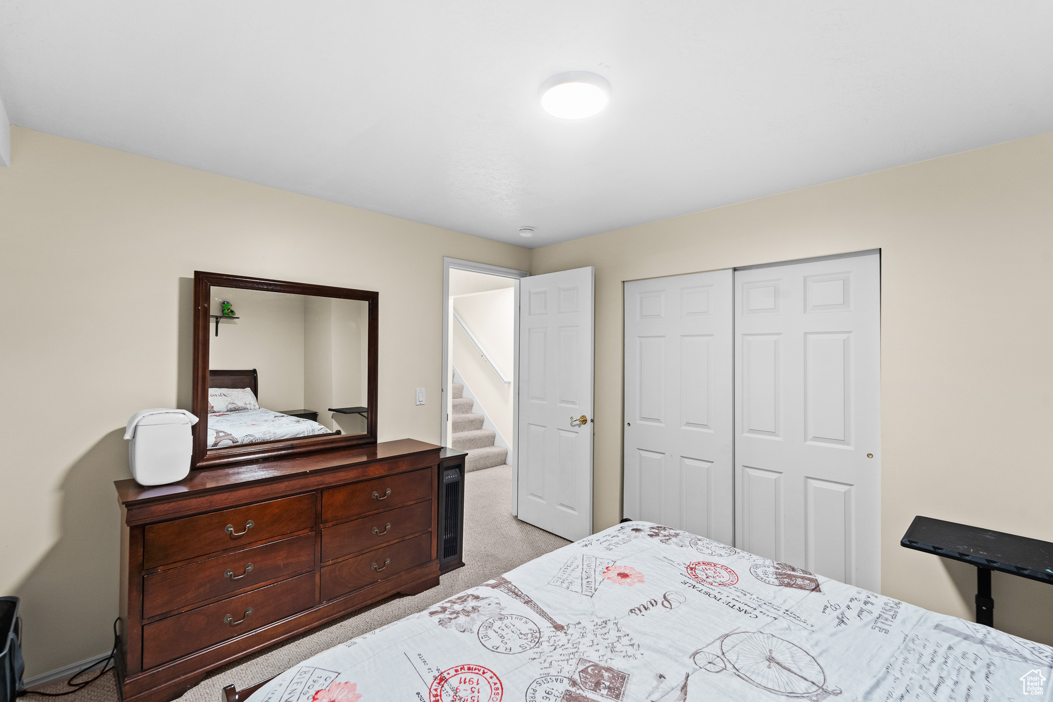 Bedroom featuring light carpet and a closet