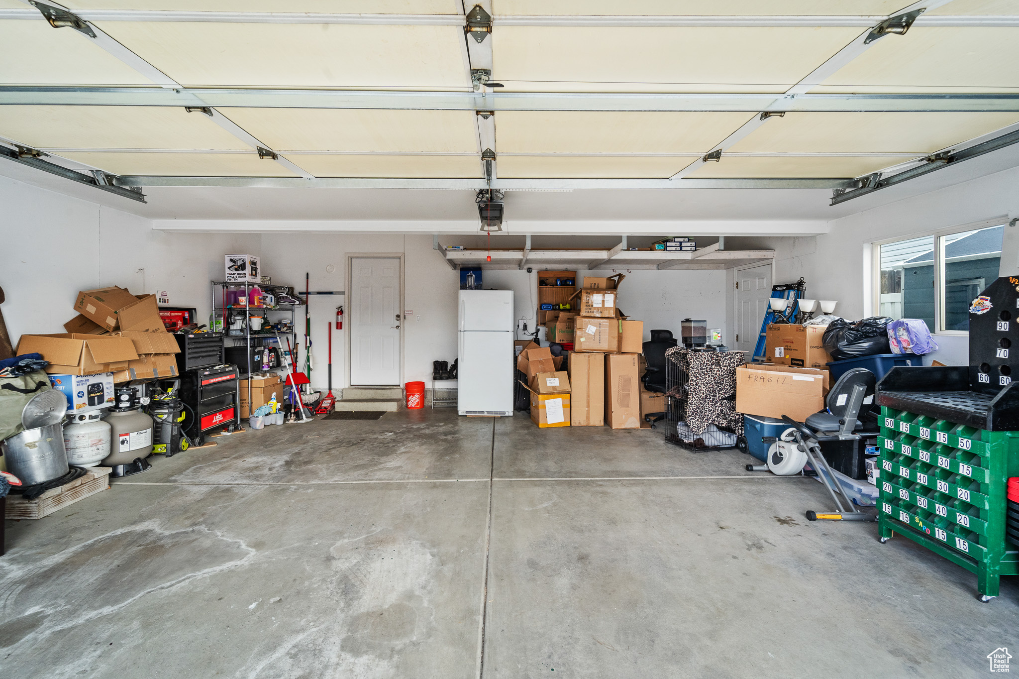 Garage with freestanding refrigerator