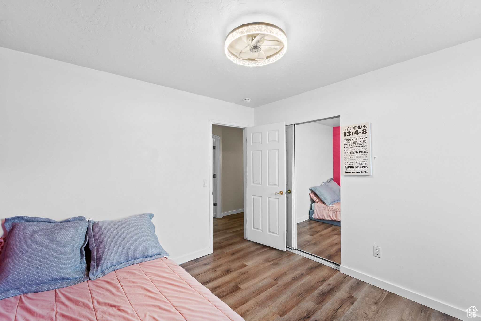 Bedroom with a closet, baseboards, and wood finished floors