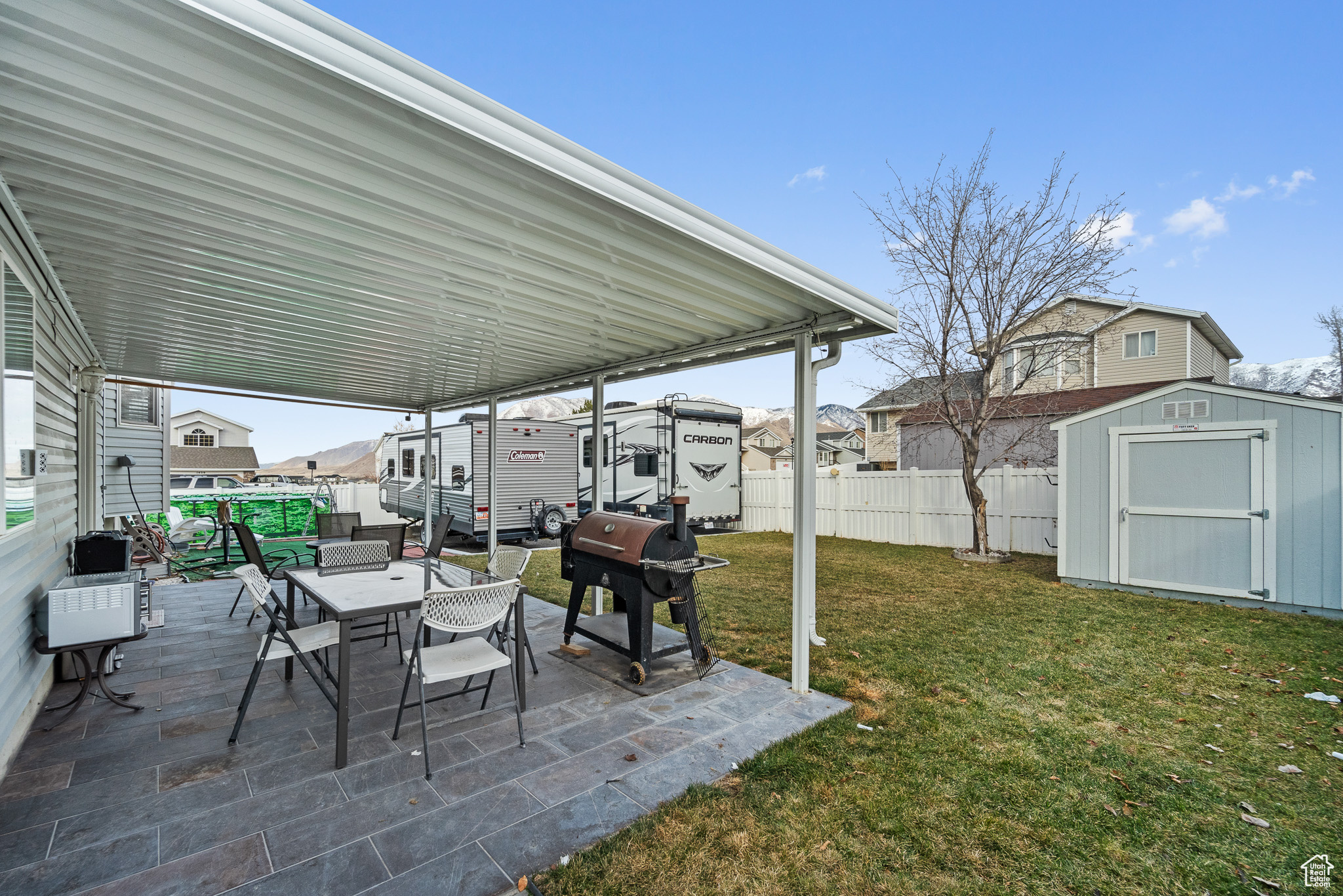 View of yard featuring an outbuilding, a storage unit, a patio area, and a fenced backyard