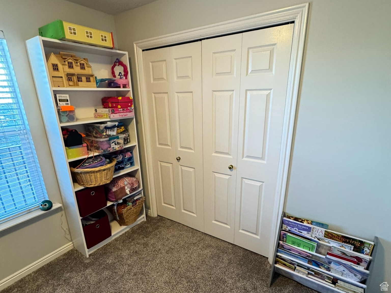 Game room with baseboards, dark colored carpet, and a textured ceiling