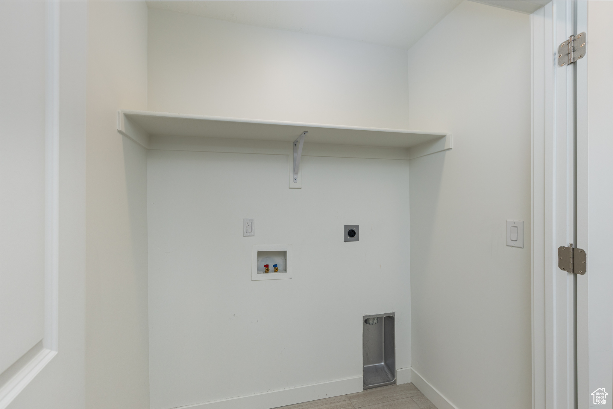 Laundry room with washer hookup, light wood finished floors, hookup for an electric dryer, laundry area, and baseboards