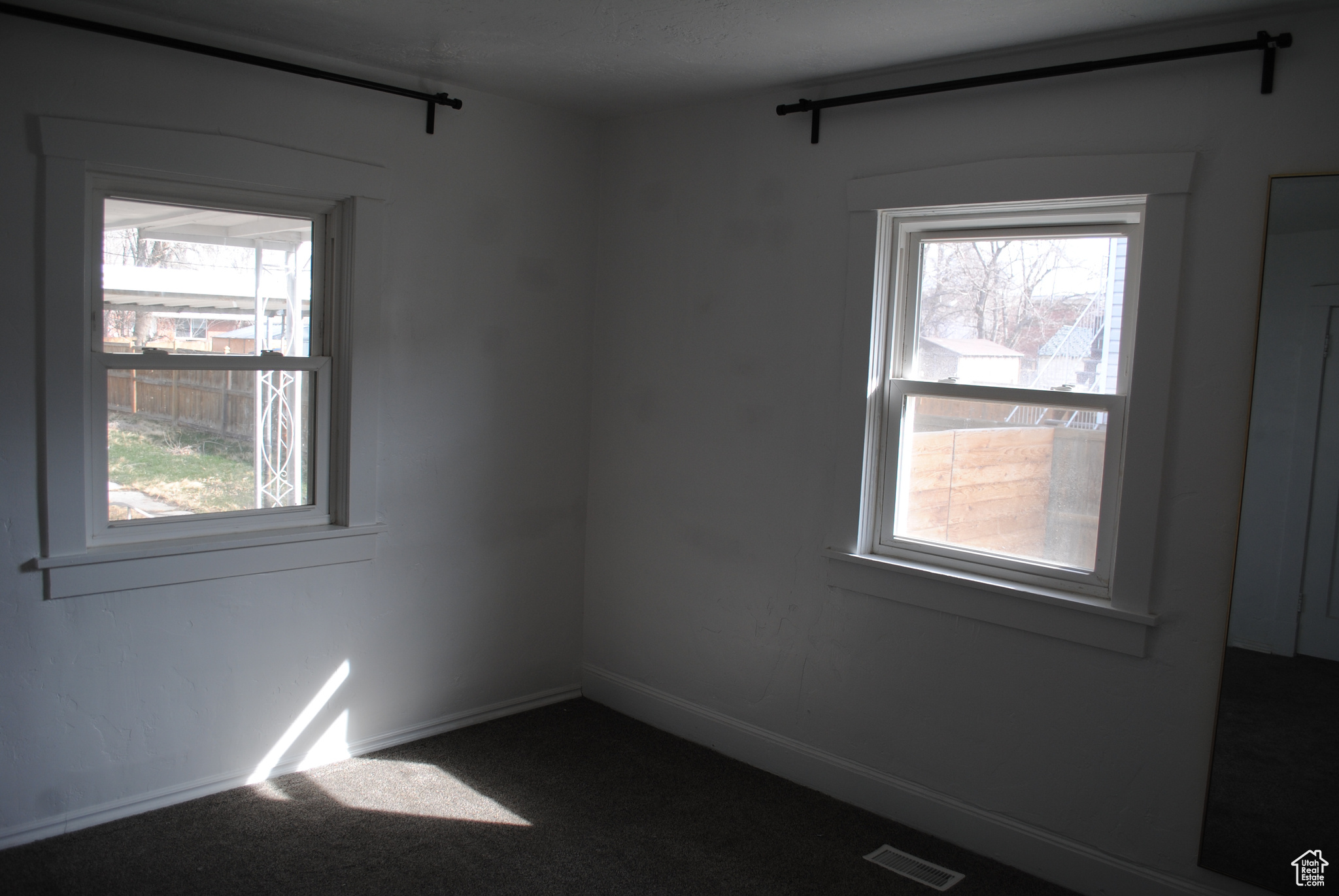 Unfurnished room with baseboards, visible vents, and carpet flooring