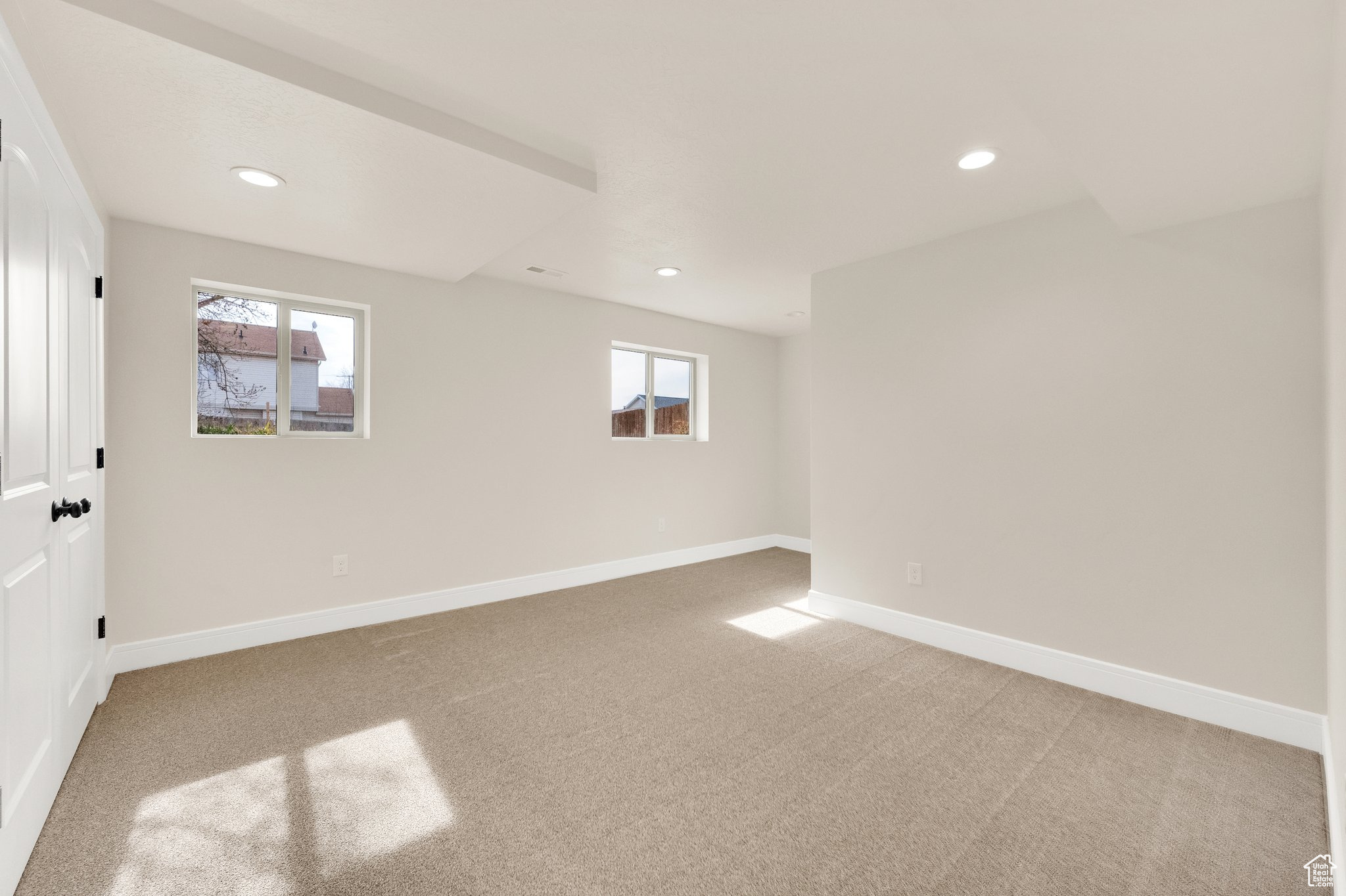 Large bedroom with two daylight windows, desk area, new carpet, new paint, can lights
