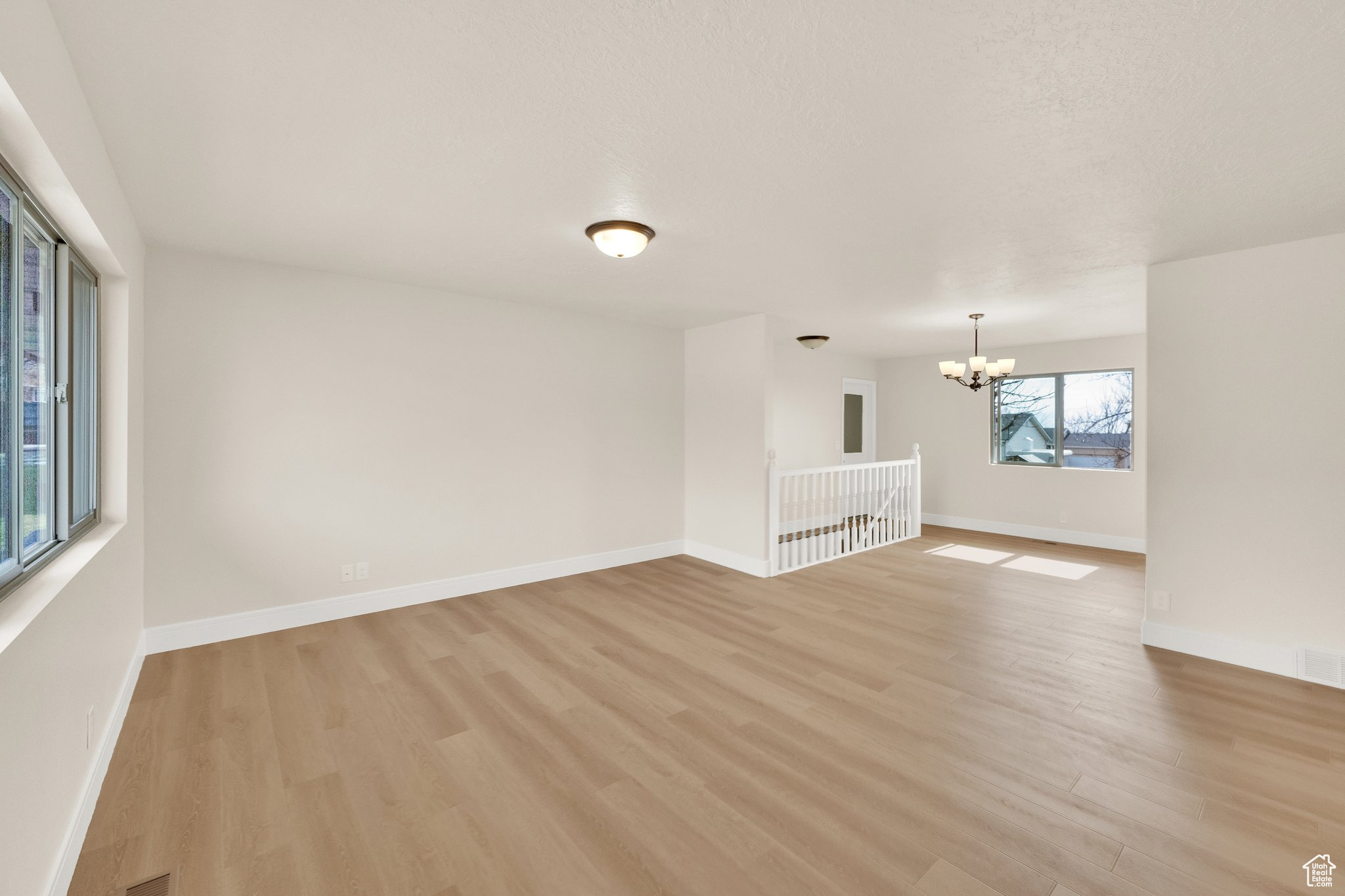 wood flooring, large windows, open floor plan