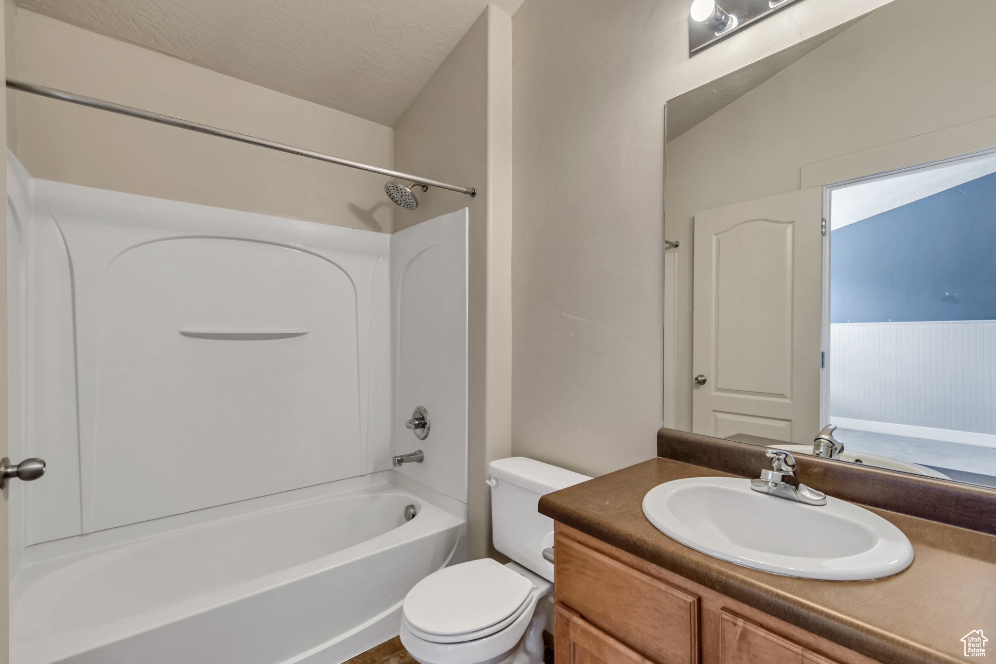 Full bathroom with  shower combination, vanity, and toilet