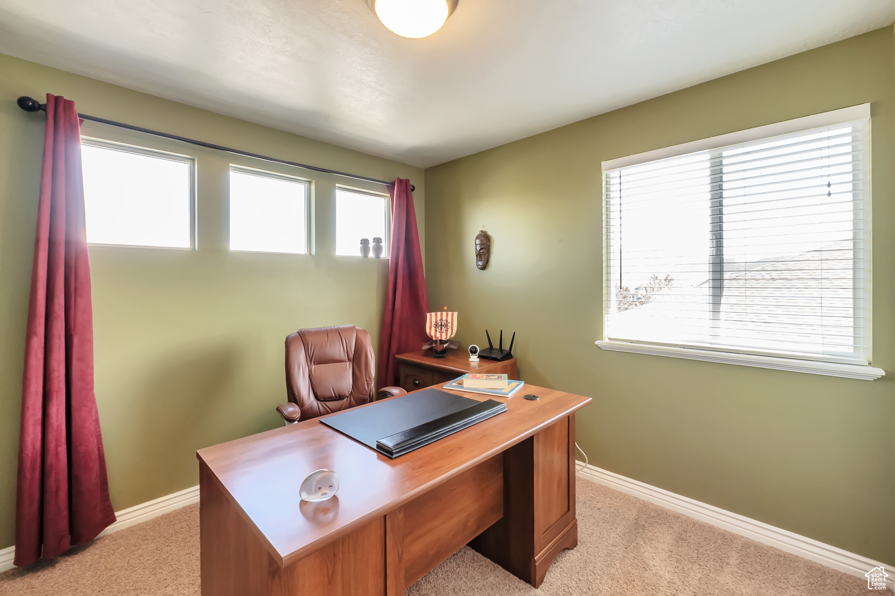 Office space featuring light colored carpet and baseboards
